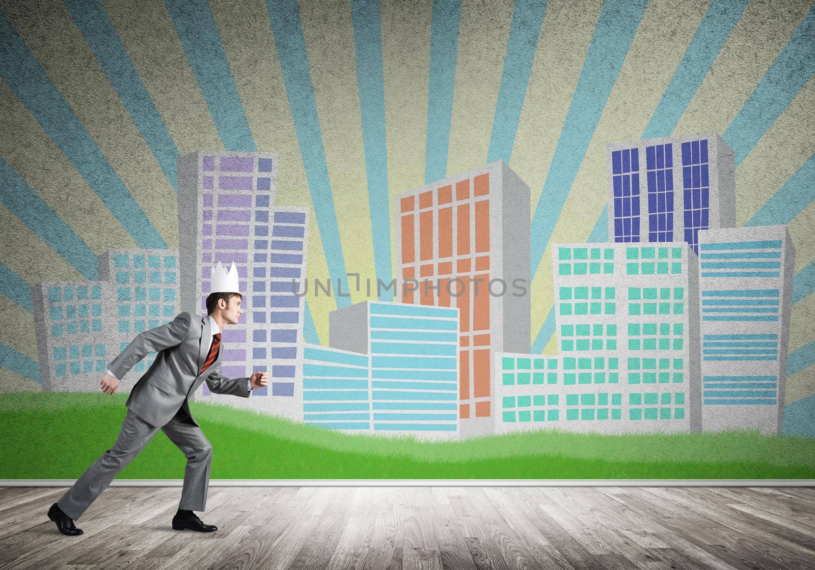 Young handsome businessman wearing white paper crown running in a hurry