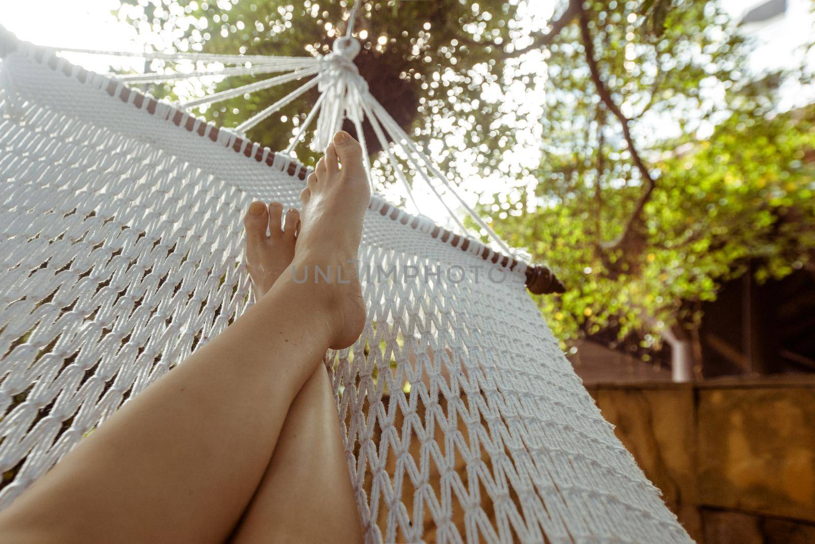 Crop person chilling in hammock by Demkat