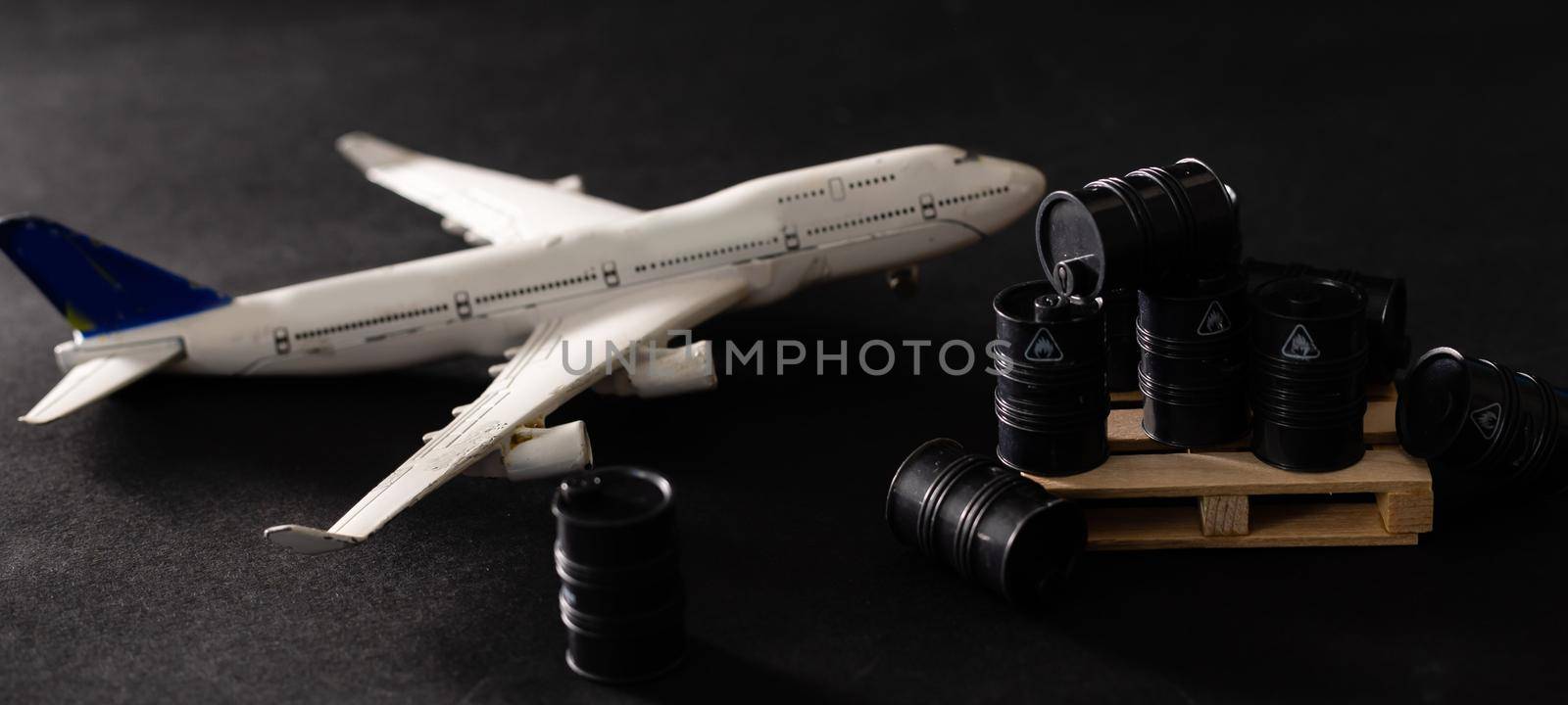 Miniature toy barrels and airplane. Business and finance concept