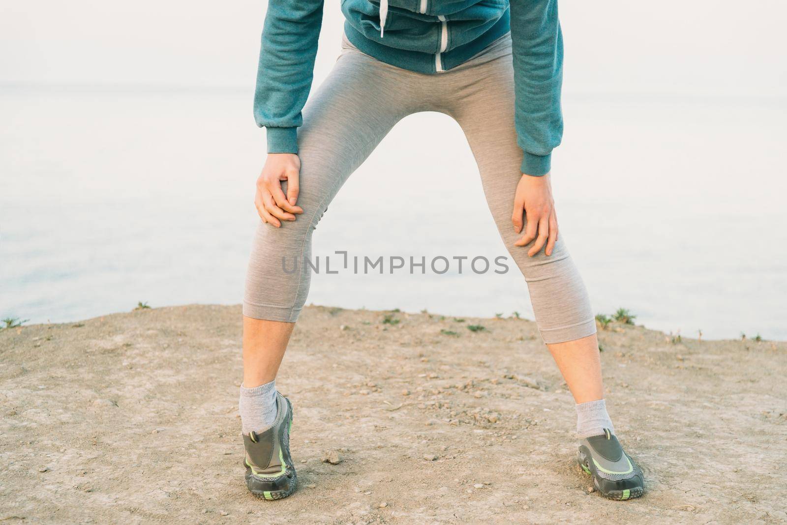 Fitness woman warming-up her knee by alexAleksei