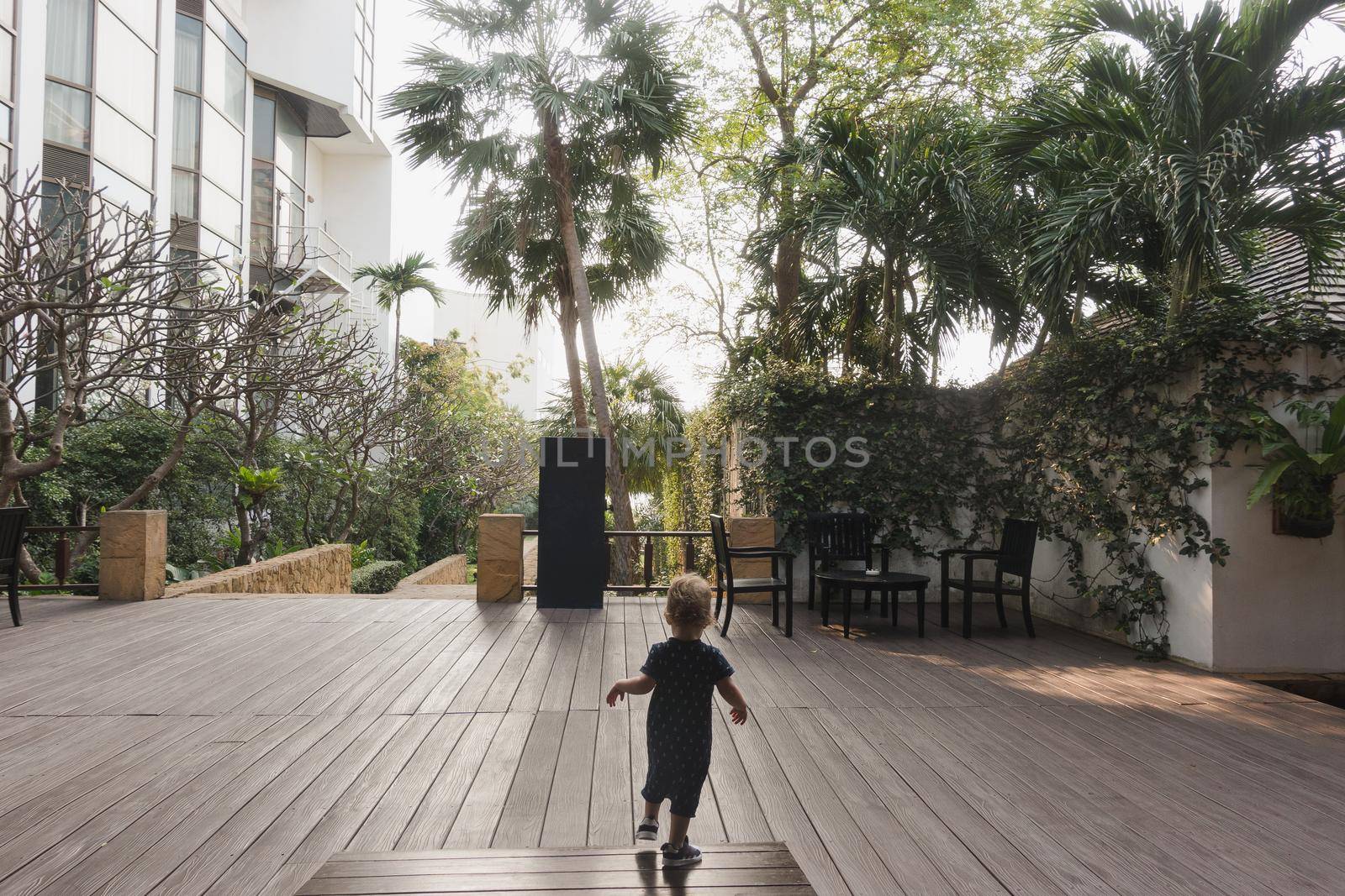 Little boy running on hotel terrace by Demkat
