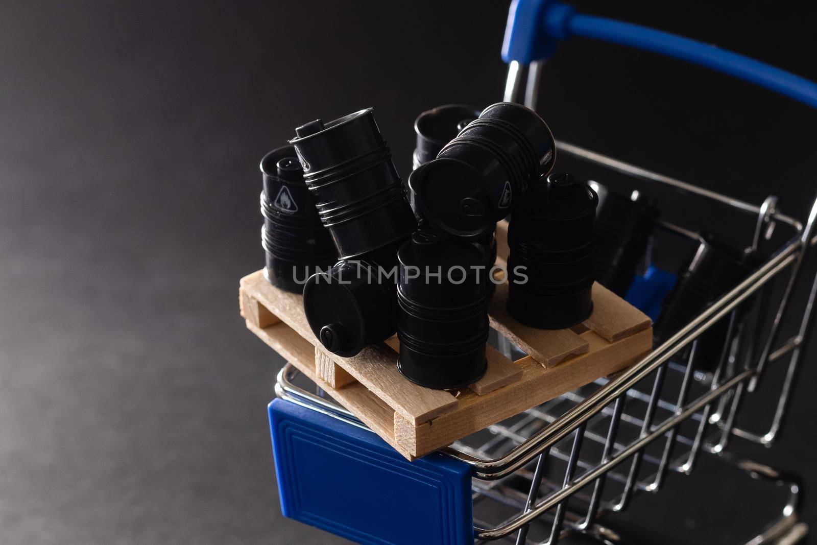 Miniatures toy barrels on a shopping cart.