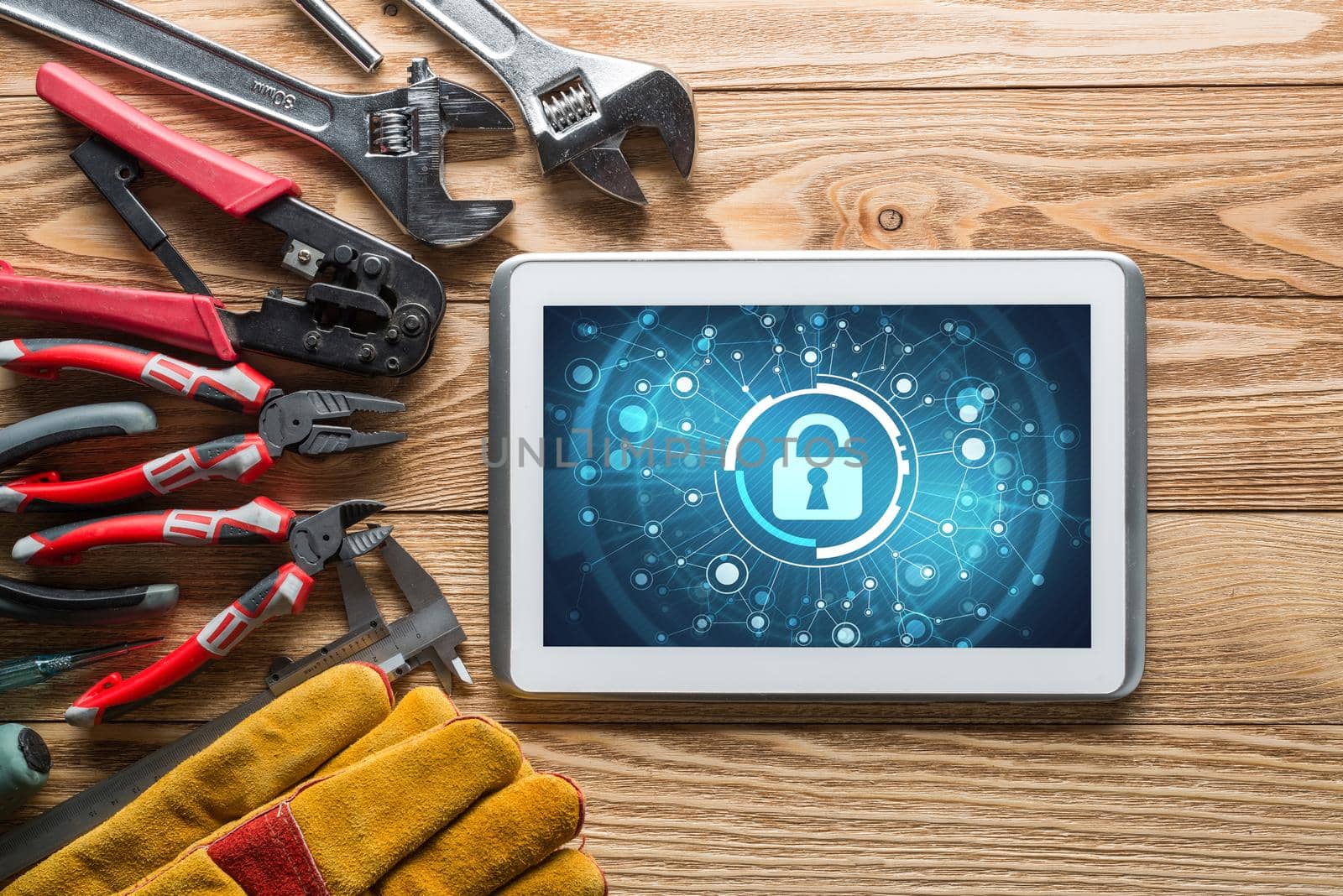 Tablet pc with security concept on screen and industrial tools around