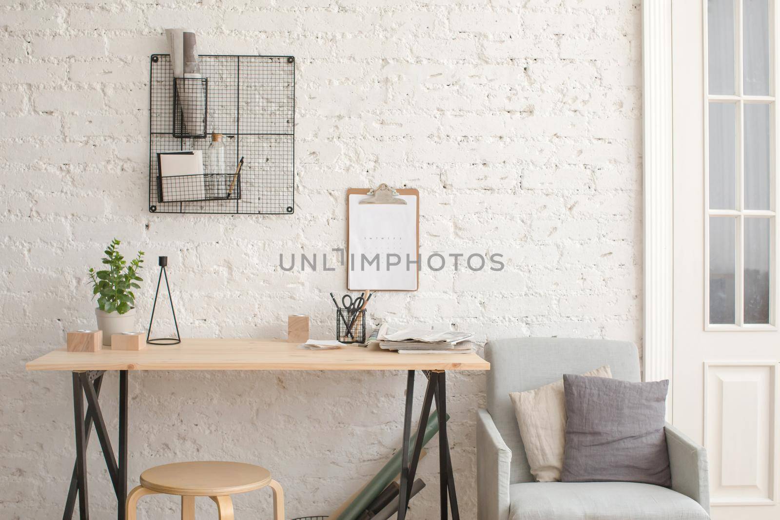 Desk with stationery in the white interior Loft workspace