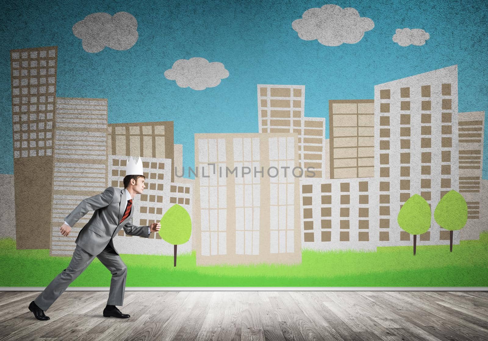 Young handsome businessman wearing white paper crown running in a hurry