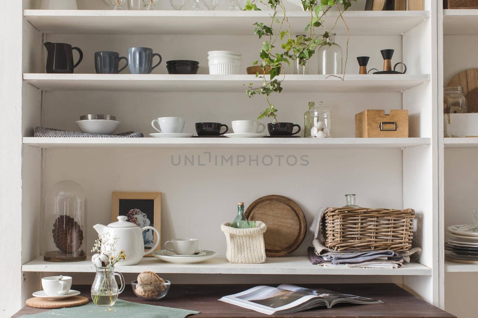 White wooden shelves with decorative elements and elegant kitchenware.