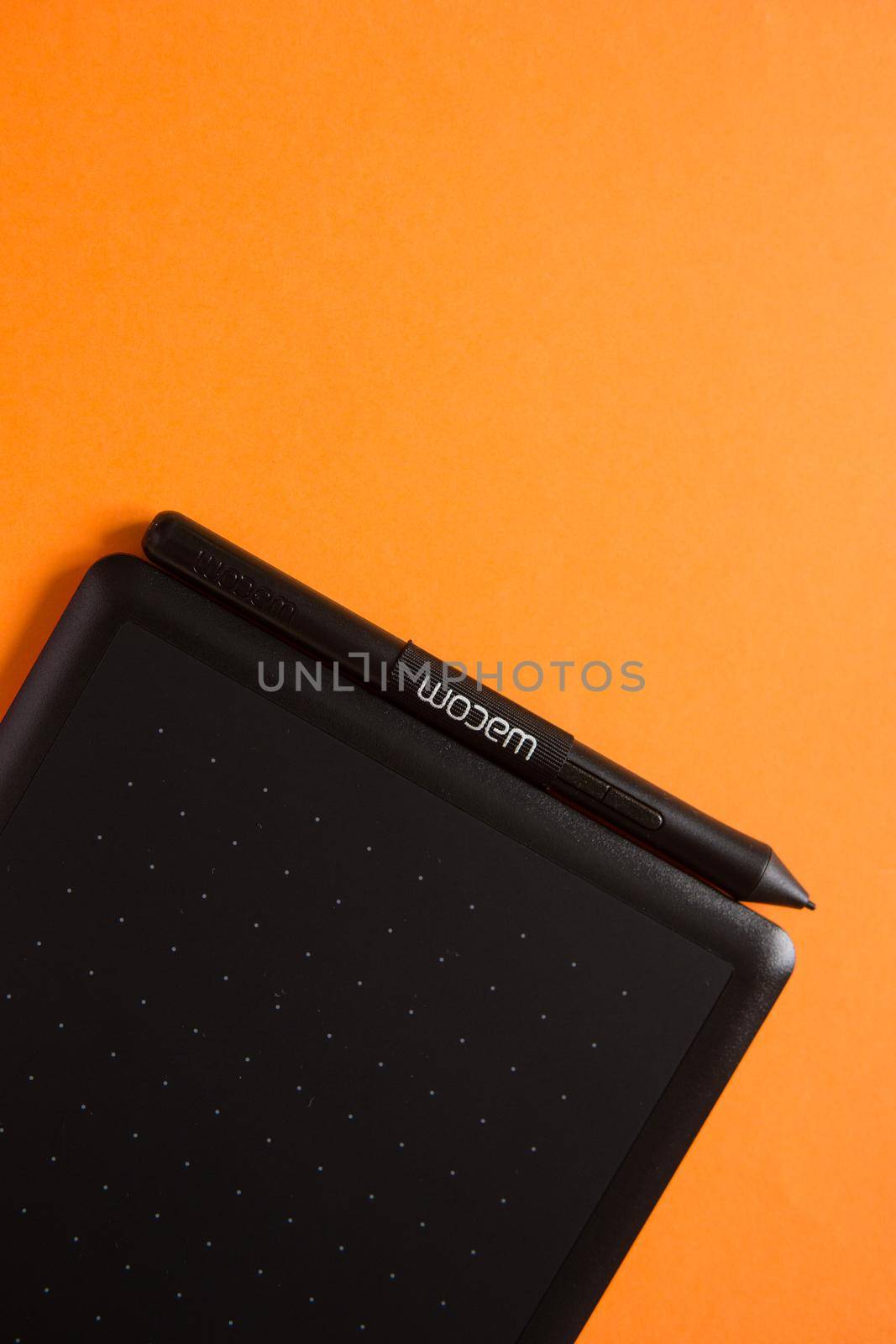 Tver, Russia - February 3, 2020; Top view of Wacom graphic tablet on orange background. Space for text. Selective focus.