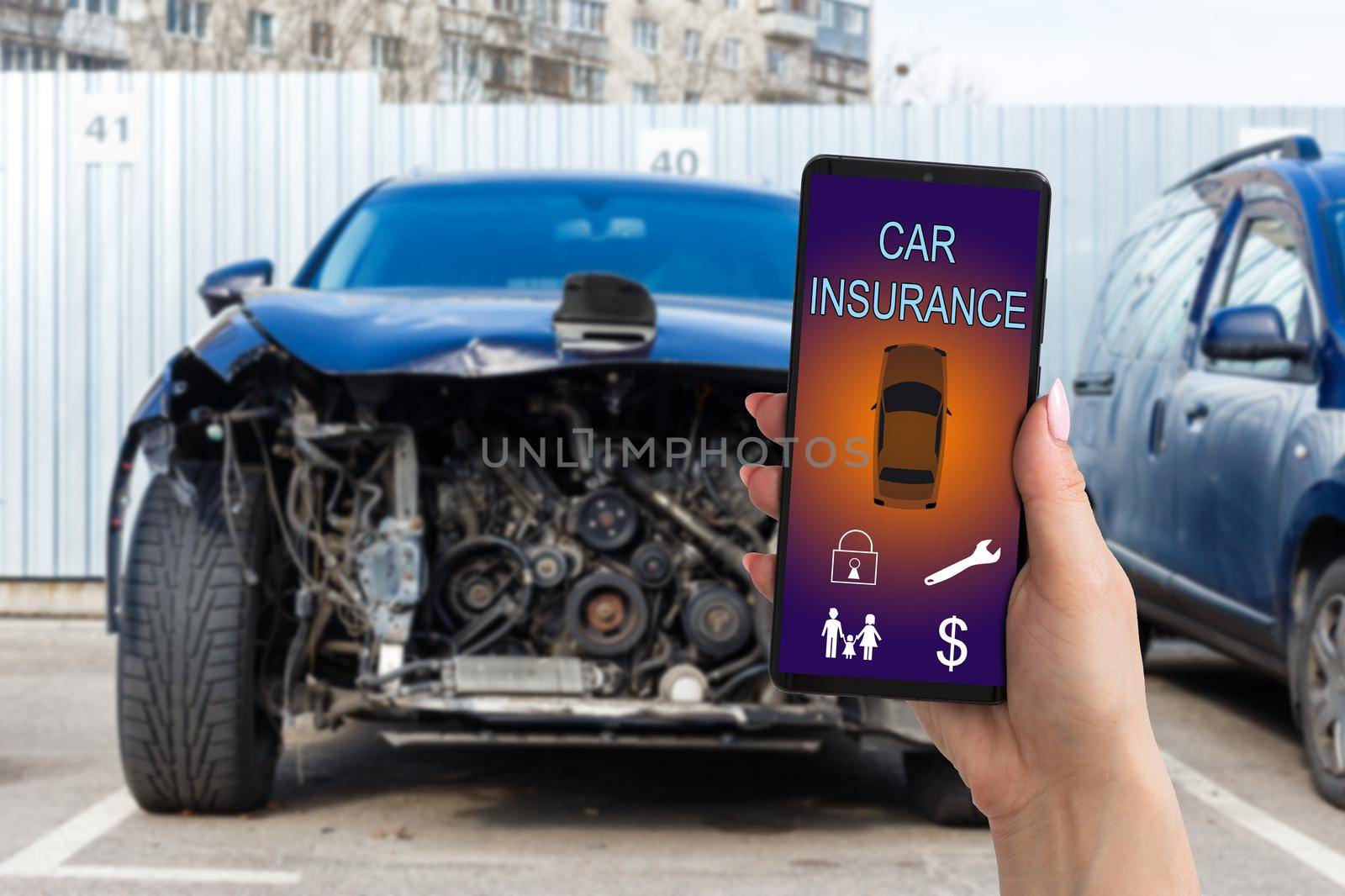 Handsome man hand holding smartphone to use car insurance application online after his broken car. Insurance concept