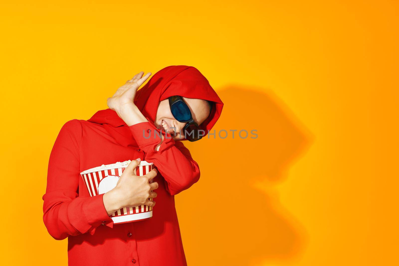 pretty woman 3d glasses technology watching movie popcorn yellow background. High quality photo