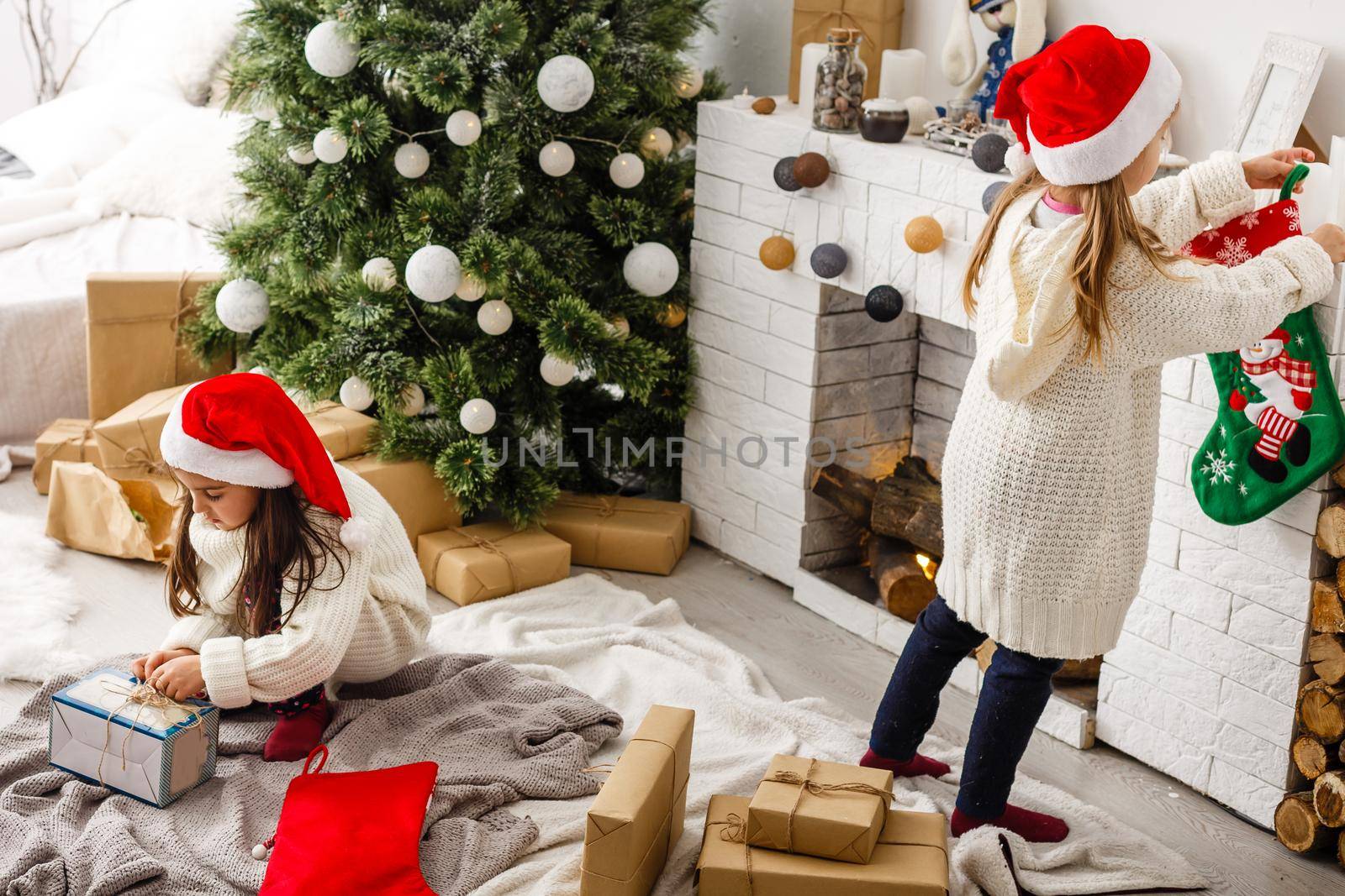 two little girls Sharing a Surprise on Christmas Morning.