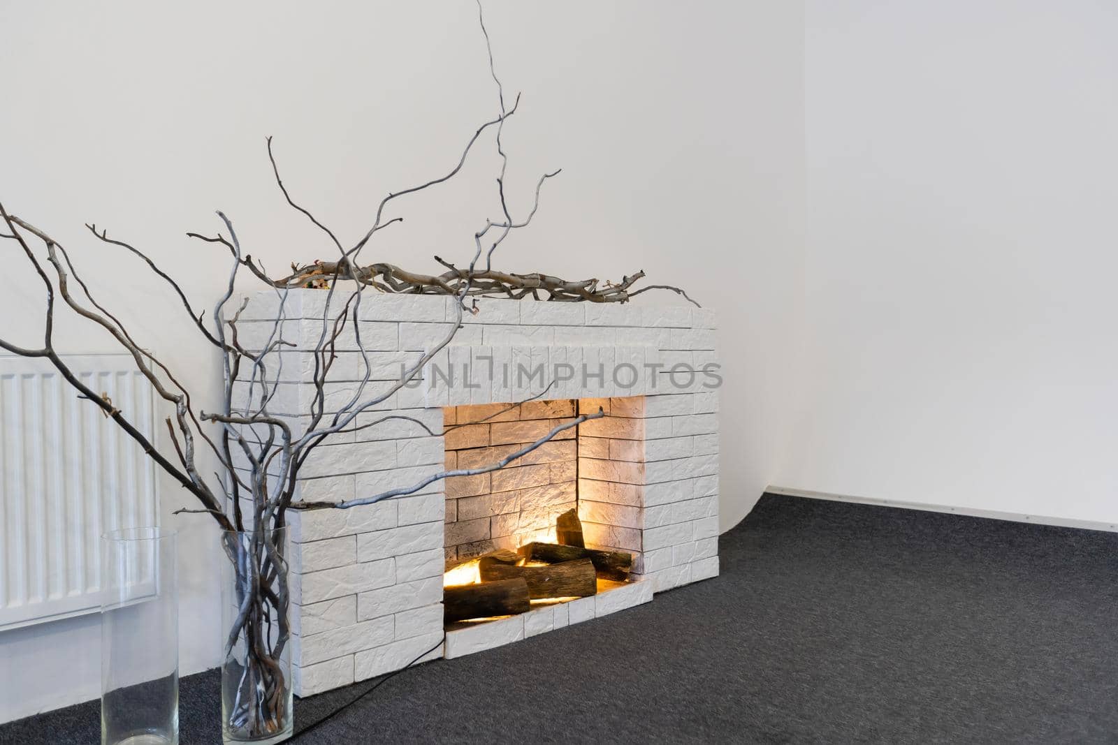 Decorative fireplace on the wall - modern interior. With a white brick