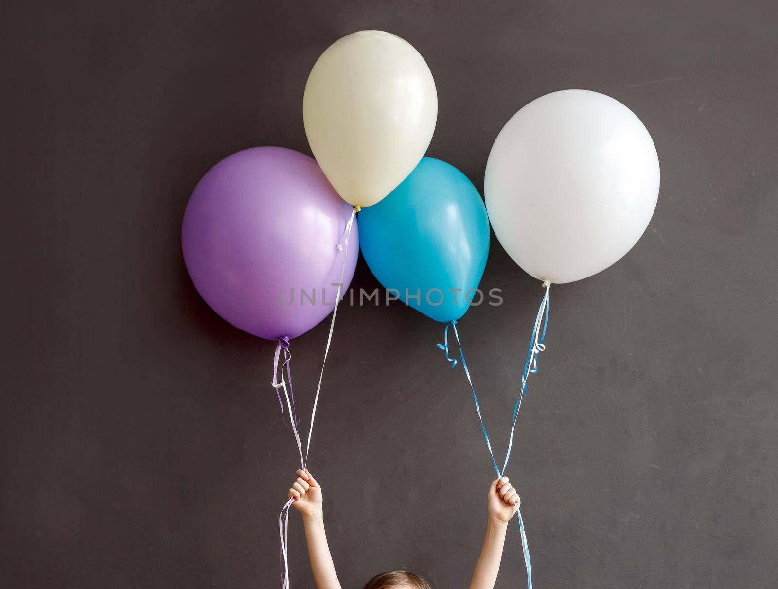Little child holding colorful balloons by Demkat