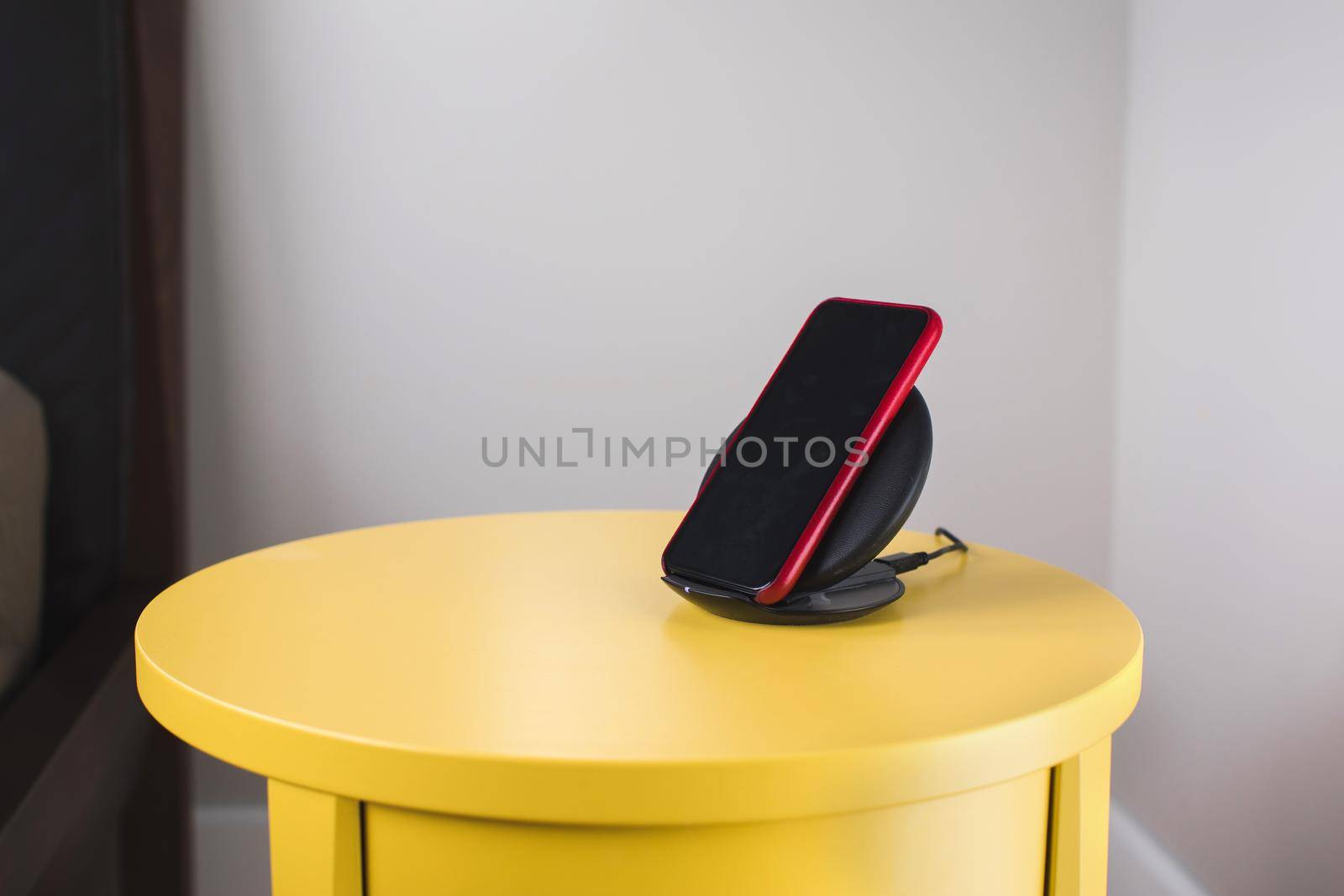 Smartphone is placed on a wireless fast charger station
