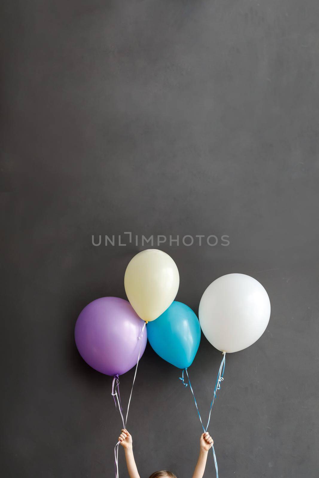 Little child holding colorful balloons by Demkat