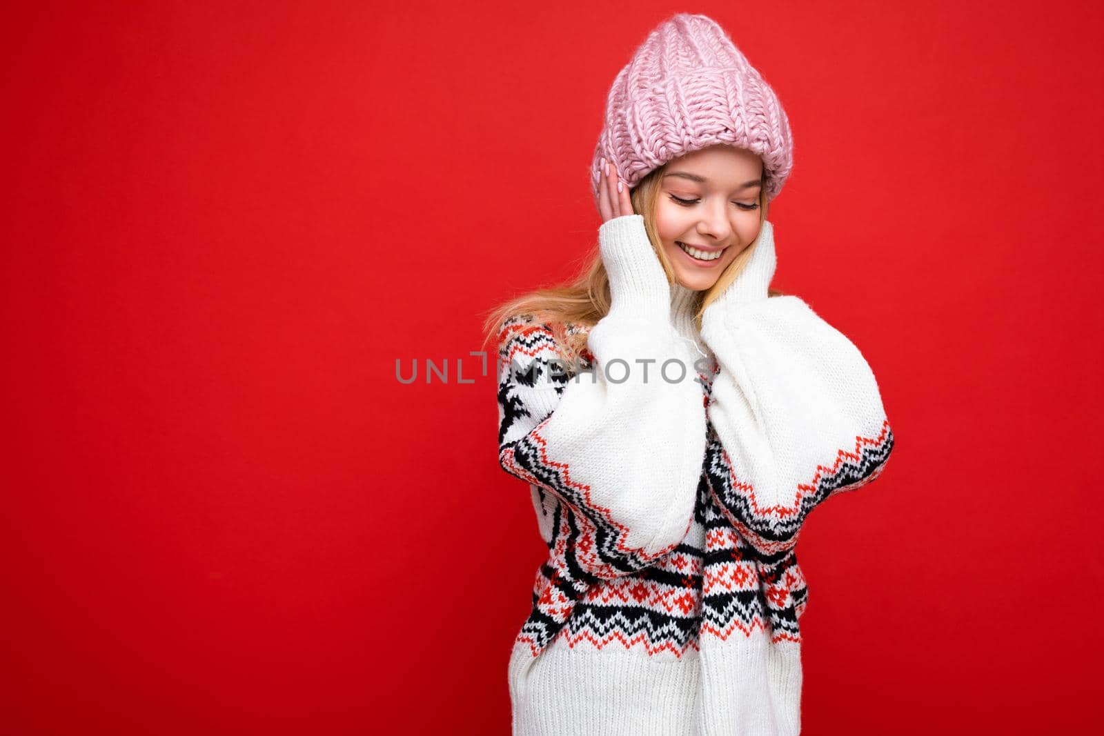 Beautiful positive happy young blonde woman isolated over colourful background wall wearing casual stylish clothes feeling sincere emotions looking to the side. Copy space