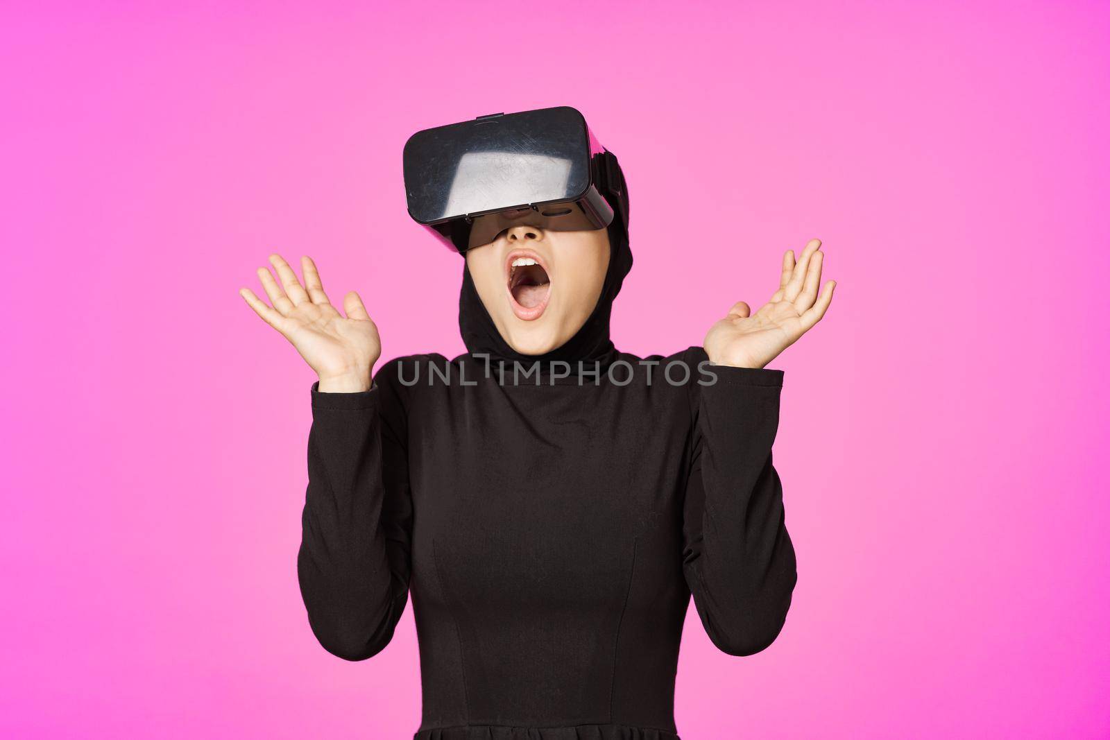 woman in black hijab glasses virtual reality technology movie watching by Vichizh