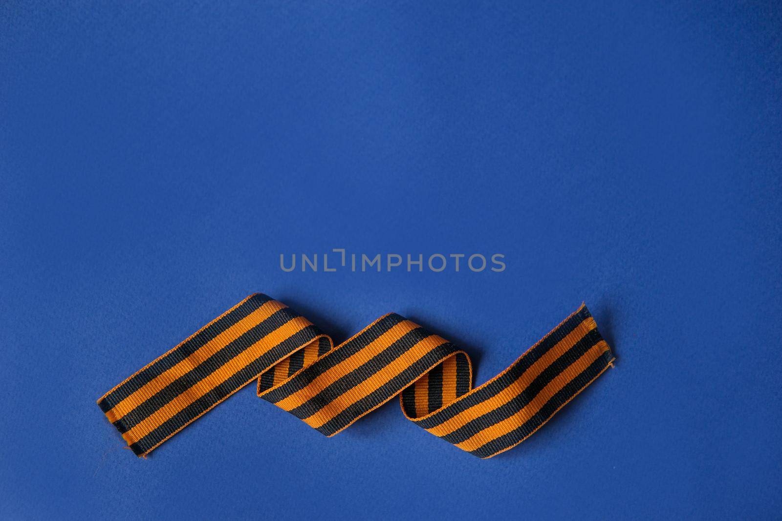 Tver Russia-may 9, 2020: 75 years of Victory in the great Patriotic war. St. George ribbon for 75 years of victory on a blue background. Happy Victory Day Space for text.