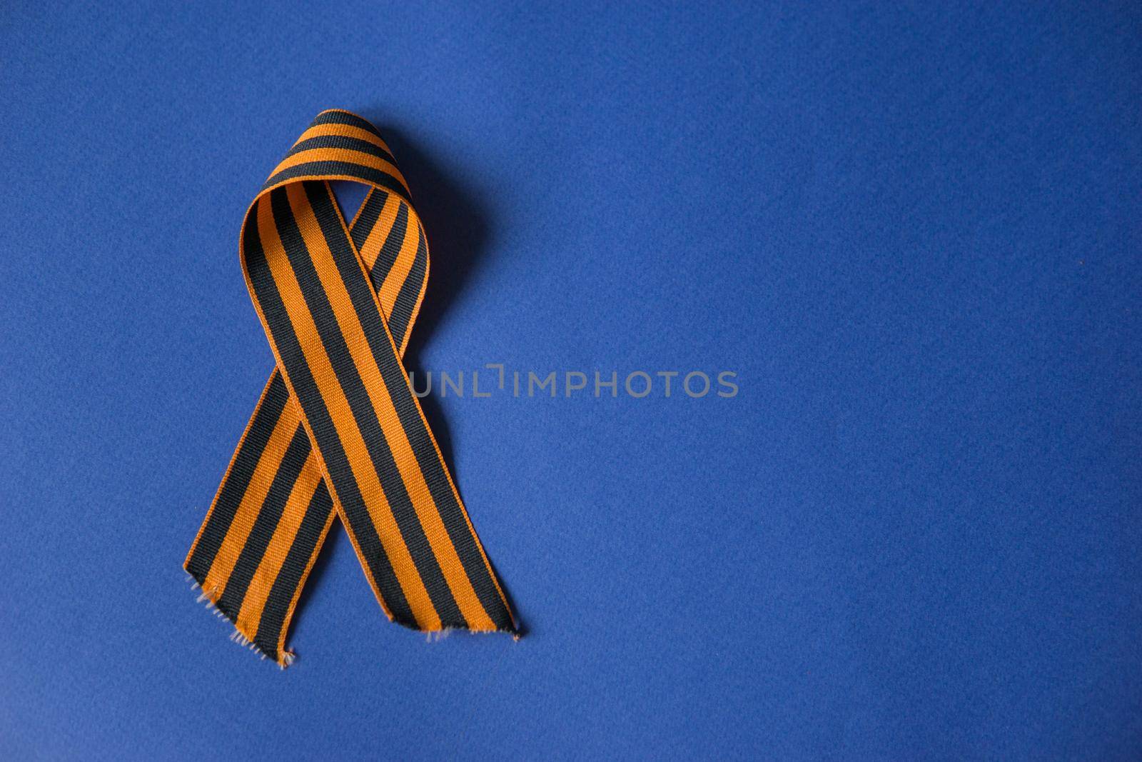 Tver Russia-may 9, 2020: 75 years of Victory in the great Patriotic war. St. George ribbon for 75 years of victory on a blue background. Happy Victory Day Space for text.