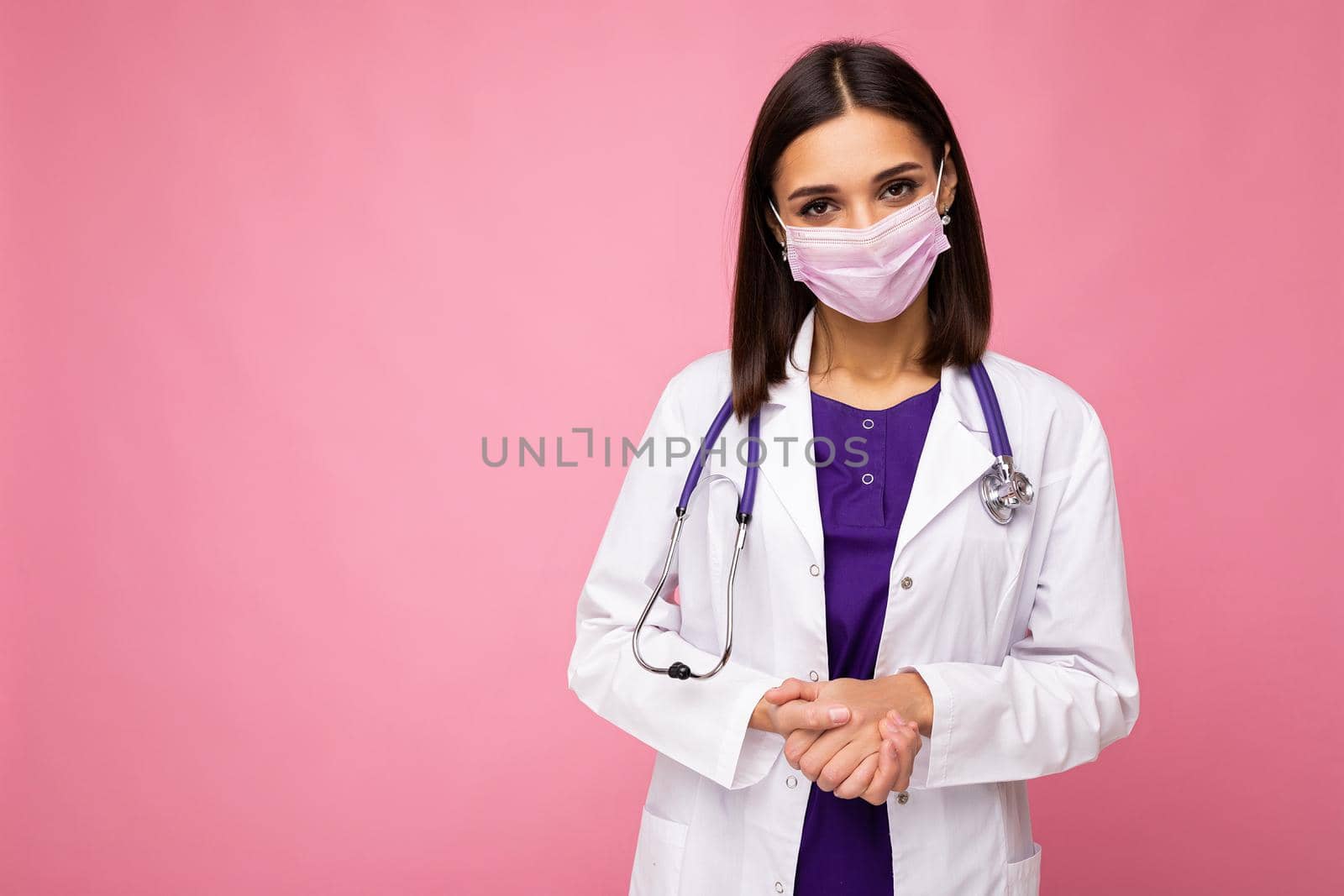 Covid19, coronavirus, healthcare and doctors concept. Photo of professional confident young european doctor in medical mask and white coat, stethoscope over neck, ready help patient, fight disease. Copy space
