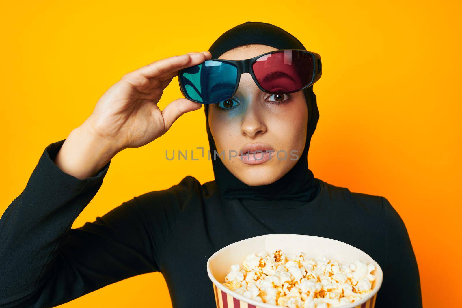arab woman watching movies 3D glasses fun studio lifestyle. High quality photo