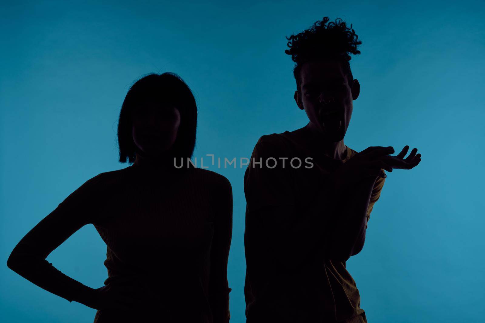 kinky guy and girl together friendship fun blue background. High quality photo