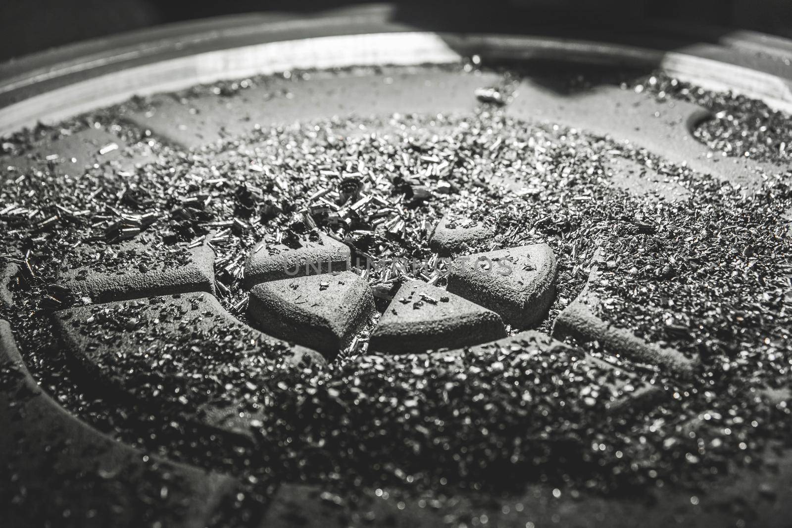 Chips after processing the cast iron hatch on the carousel machine in the workshop of the industrial plant.