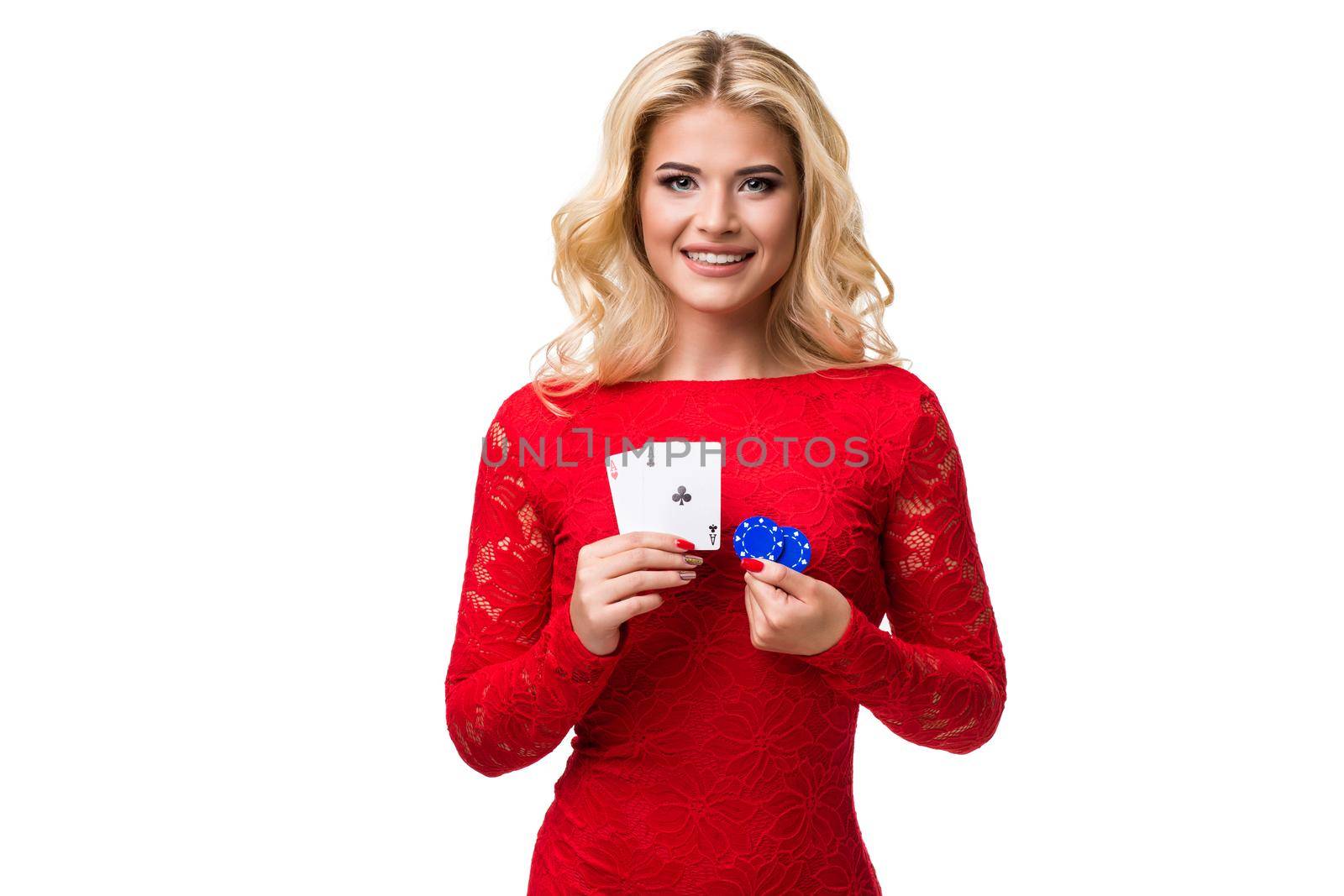 Caucasian young woman with long light blonde hair in evening outfit holding playing cards and chips. Isolated on white background. Poker