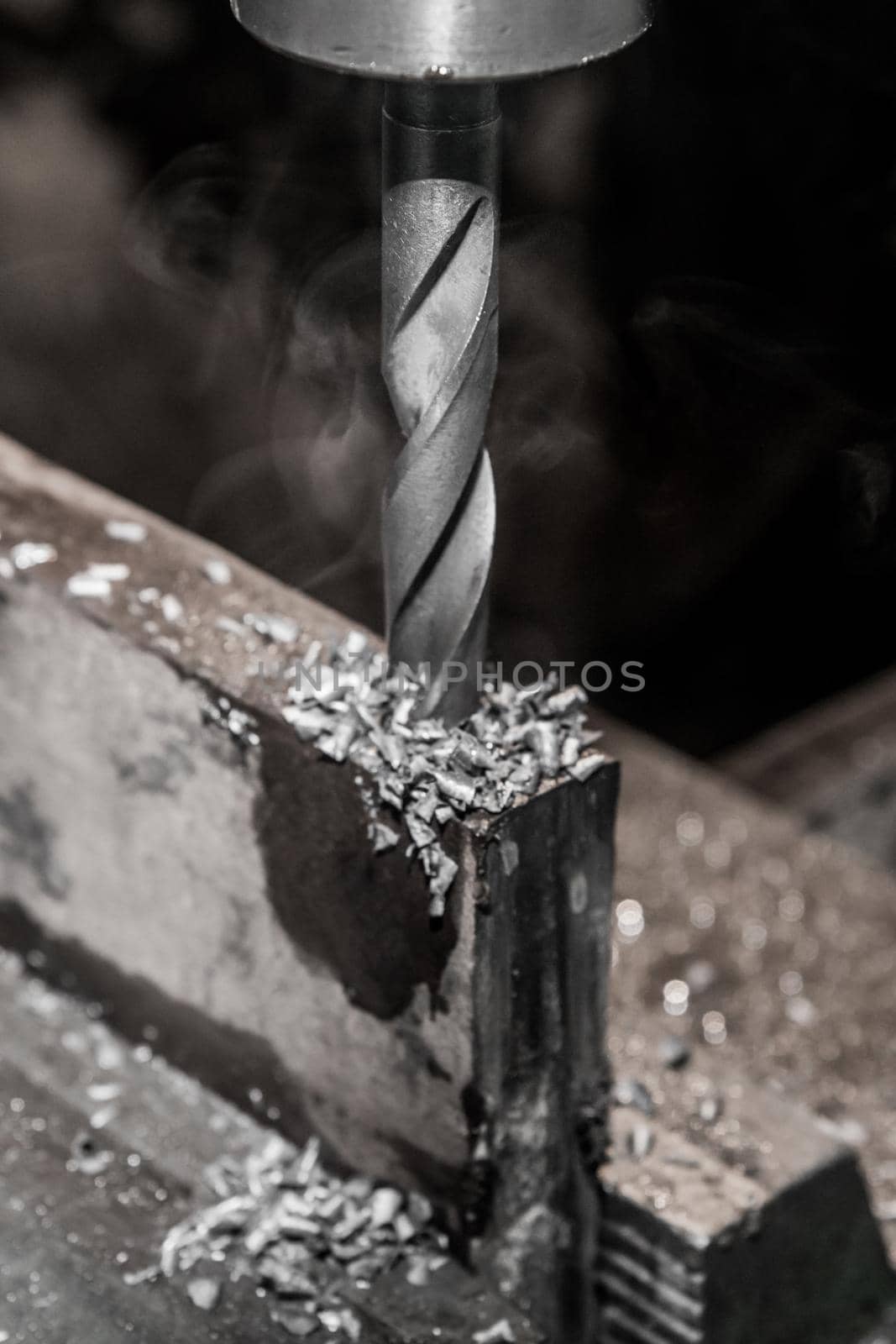 Thick drill drilling old iron bar, steel work equipment close-up by AYDO8