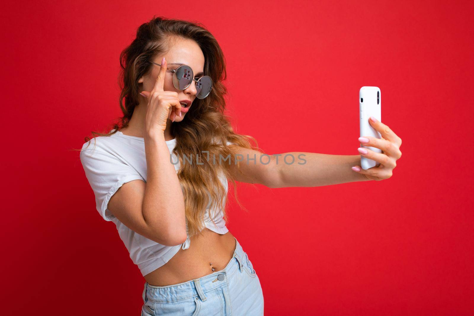 Close-up portrait nice-looking charming attractive lady making taking selfie isolated over bright vivid shine red background by TRMK