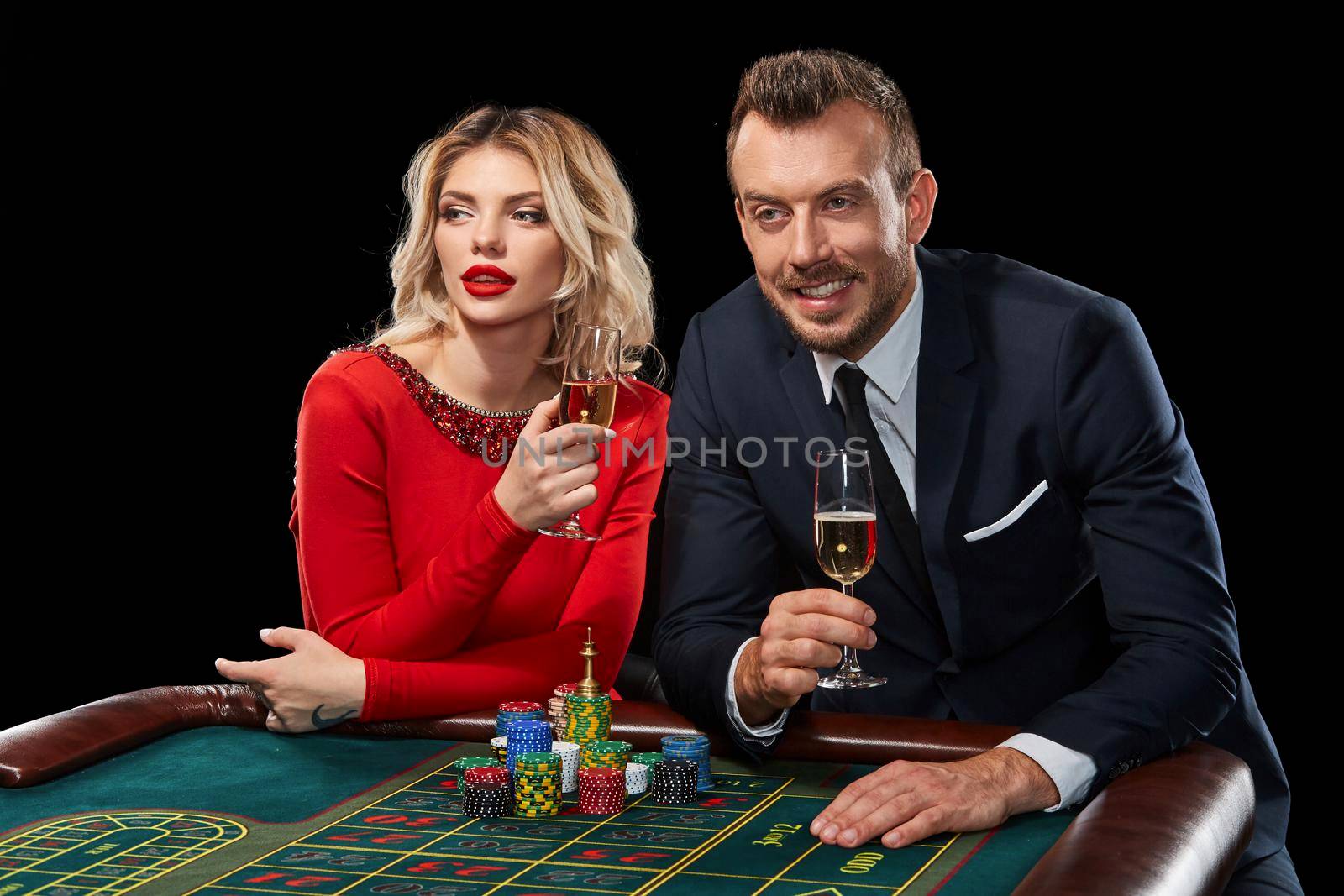 Couple playing roulette wins at the casino. Addiction to the gambling. celebrating the victory and win