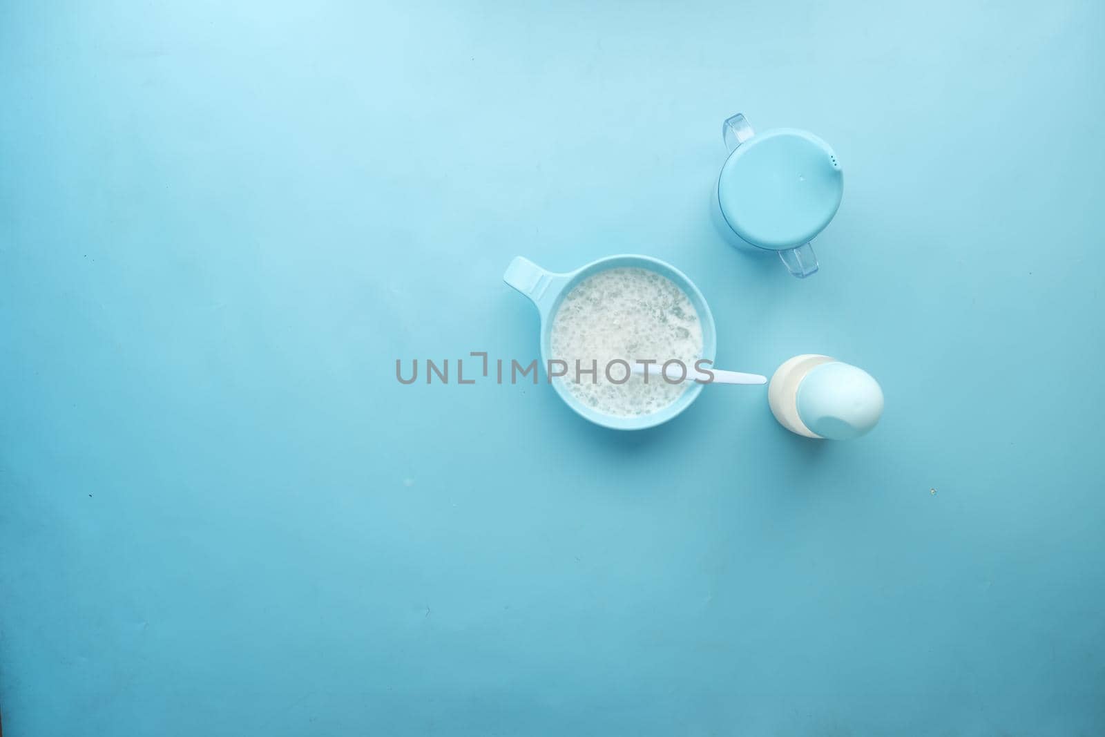 Close up of baby food in a bowl on blue background ,