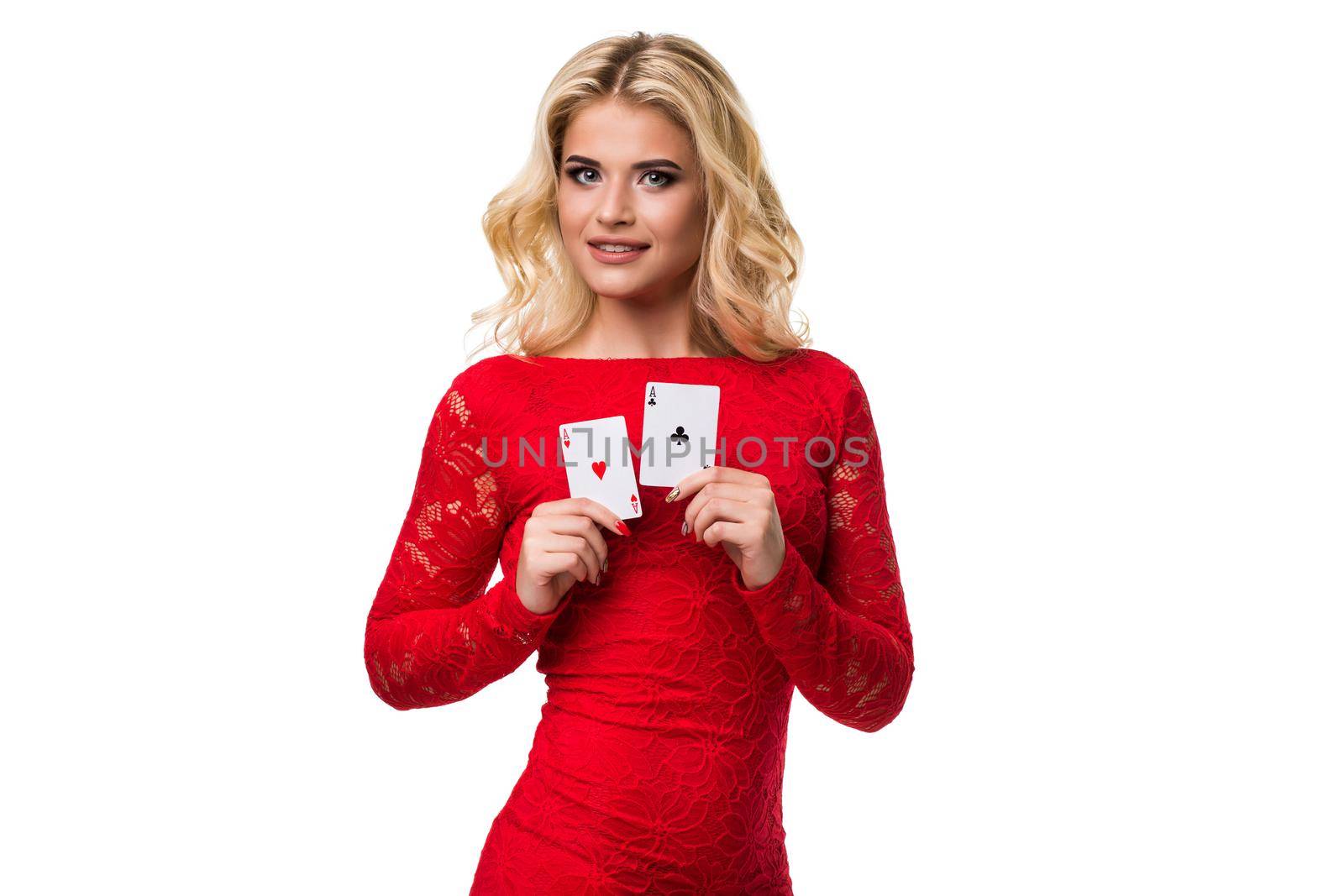 Caucasian young woman with long light blonde hair in evening outfit holding playing cards. Isolated on white background. Poker