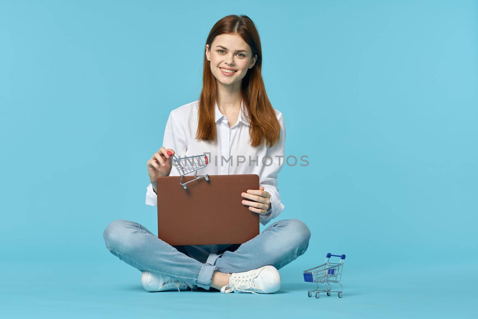 woman with laptop learning internet online education blue background. High quality photo