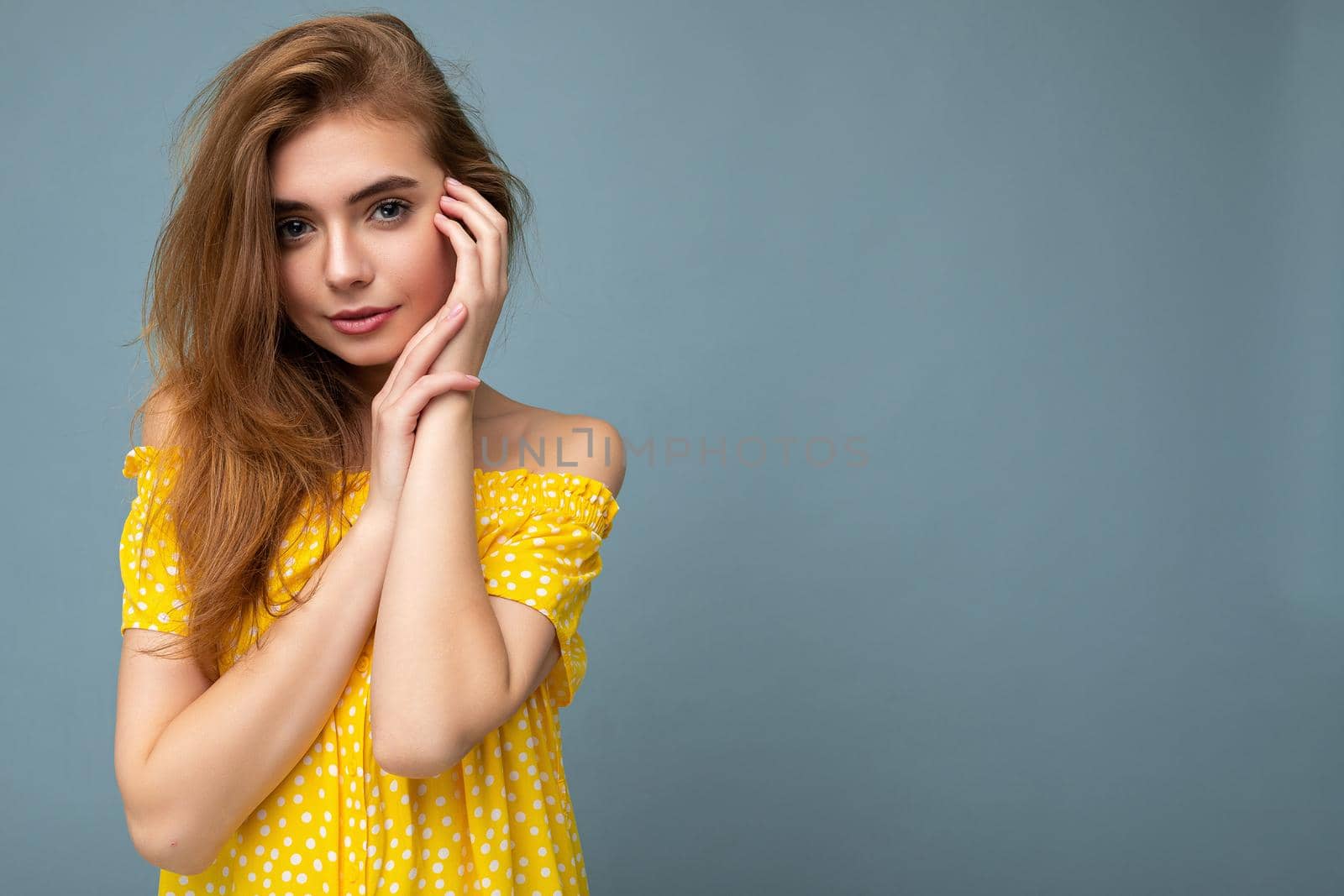 Adult cute sexy happy beautiful woman with sincere emotions isolated on background wall with copy space wearing stylish summer yellow dress. Positive concept.