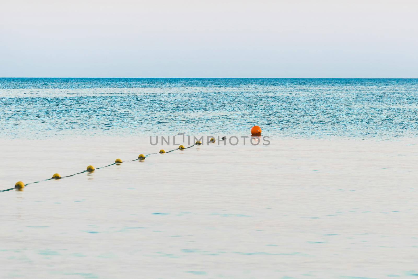 Limiting swimming buoys on the sea background in the evening.