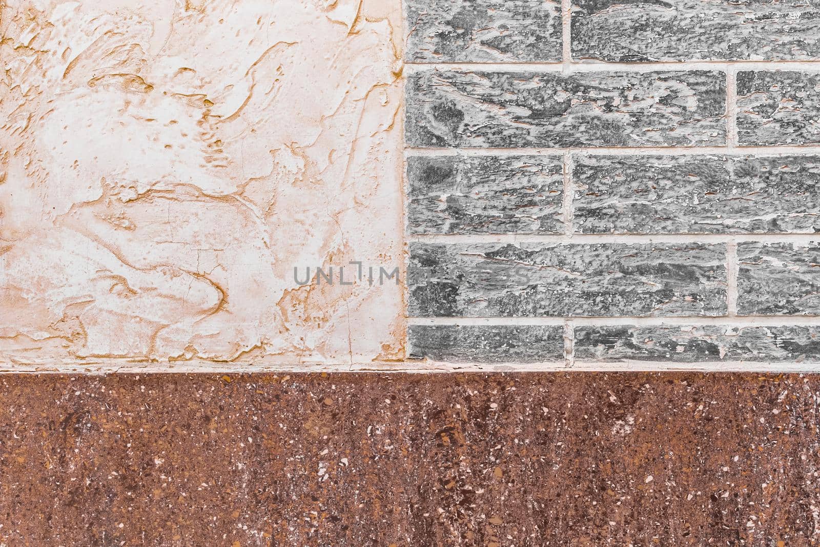 Part of modern building facade with white stucco and brown tiles texture and brick wall with abstract patterned background.