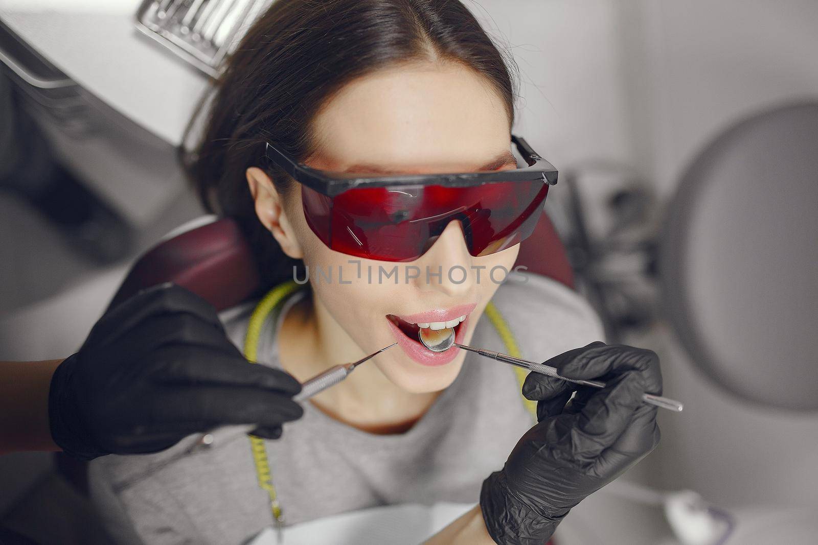 Beautiful lady in the dentist's office. Brunette sitting in a chair