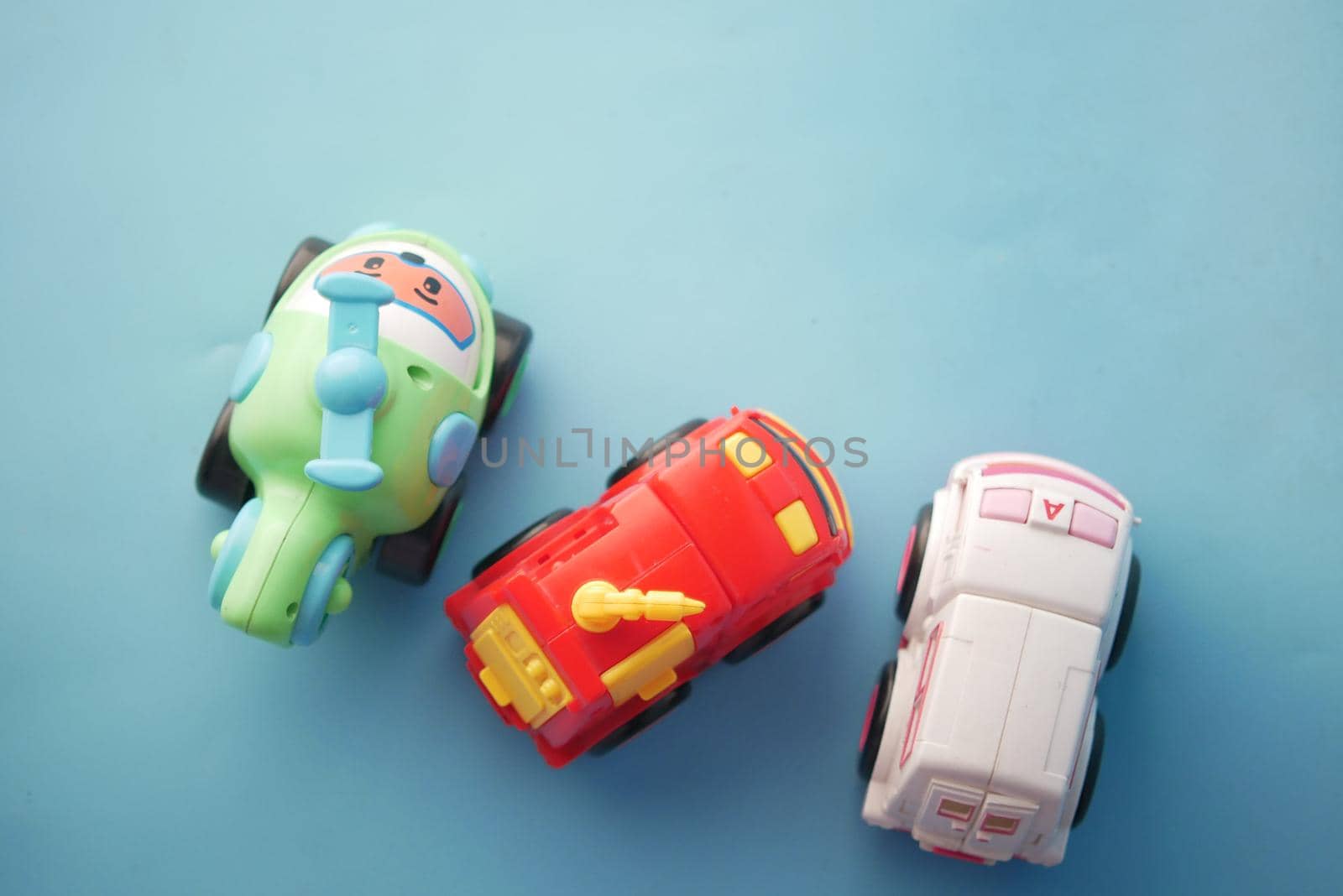 colorful plastic toys on blue background .