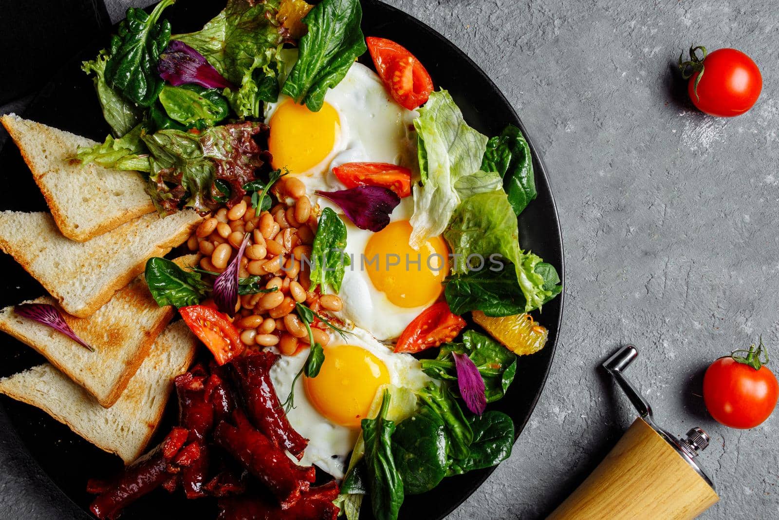 Great breakfast with fried eggs, toast, lettuce and tomato. Photographed in the vicinity by UcheaD