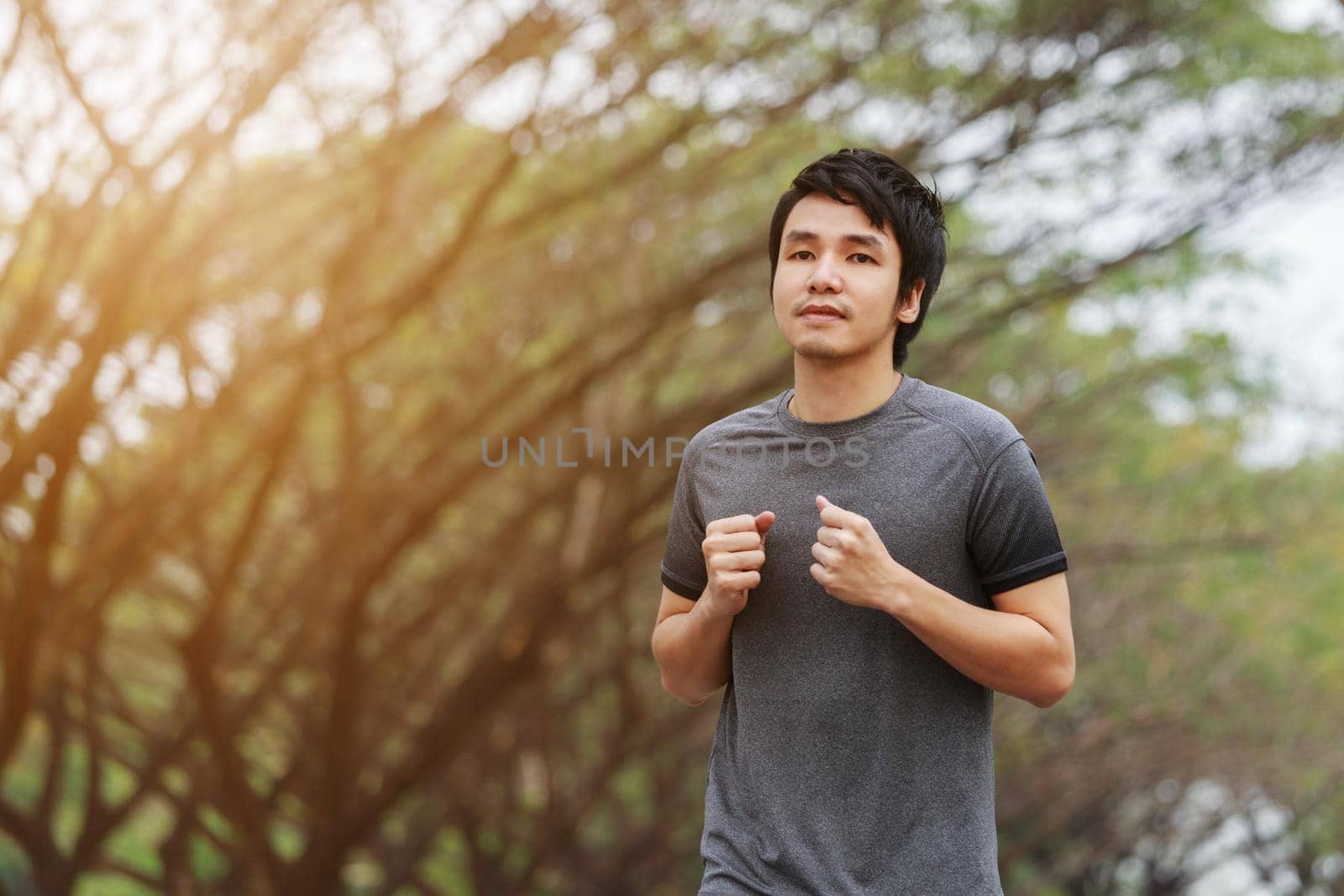 young fitness man running in the park