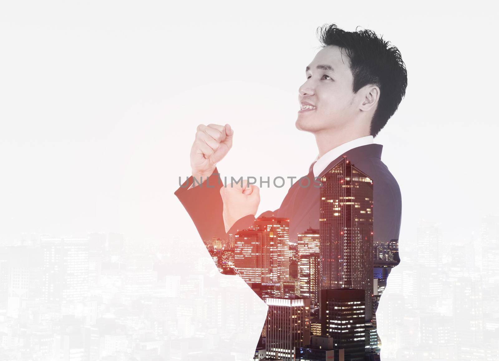 Double exposure of winning businessman against the city