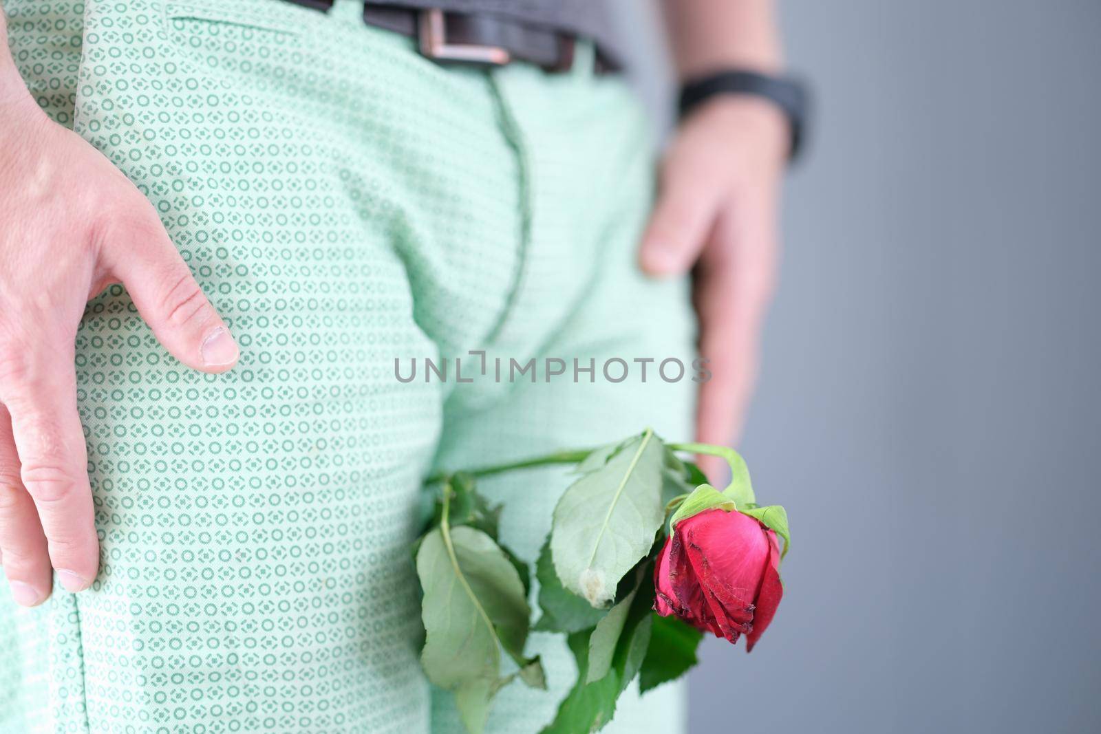 Withered flower between the man legs closeup by kuprevich