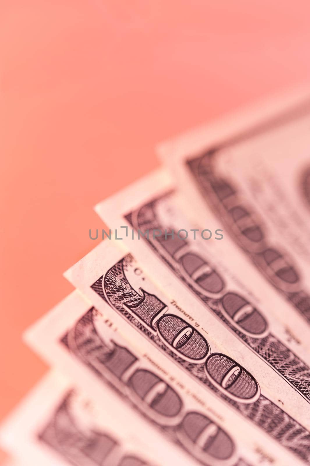 Closeup view of cash money dollars bills on a pink background. Finance and business theme. by bashta