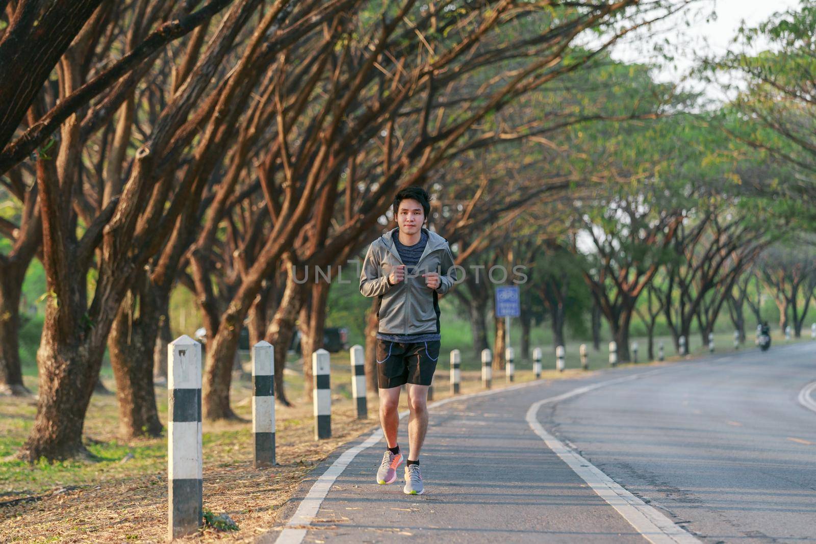 fitness man running in park by geargodz