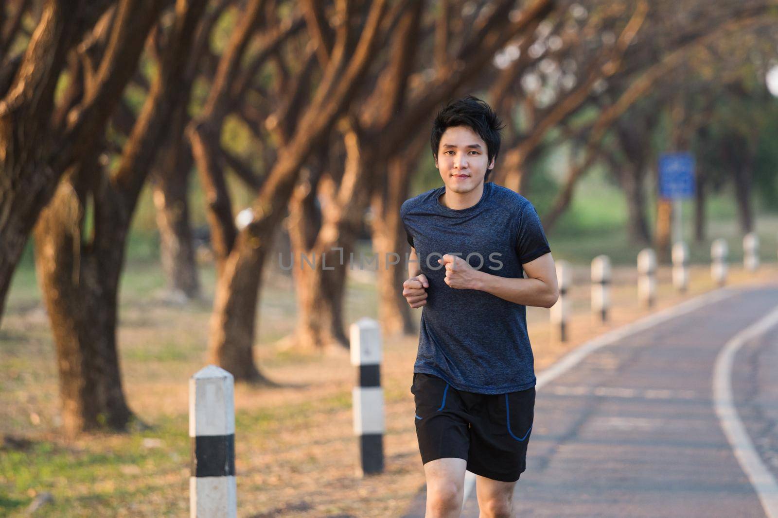 fitness man running in park by geargodz