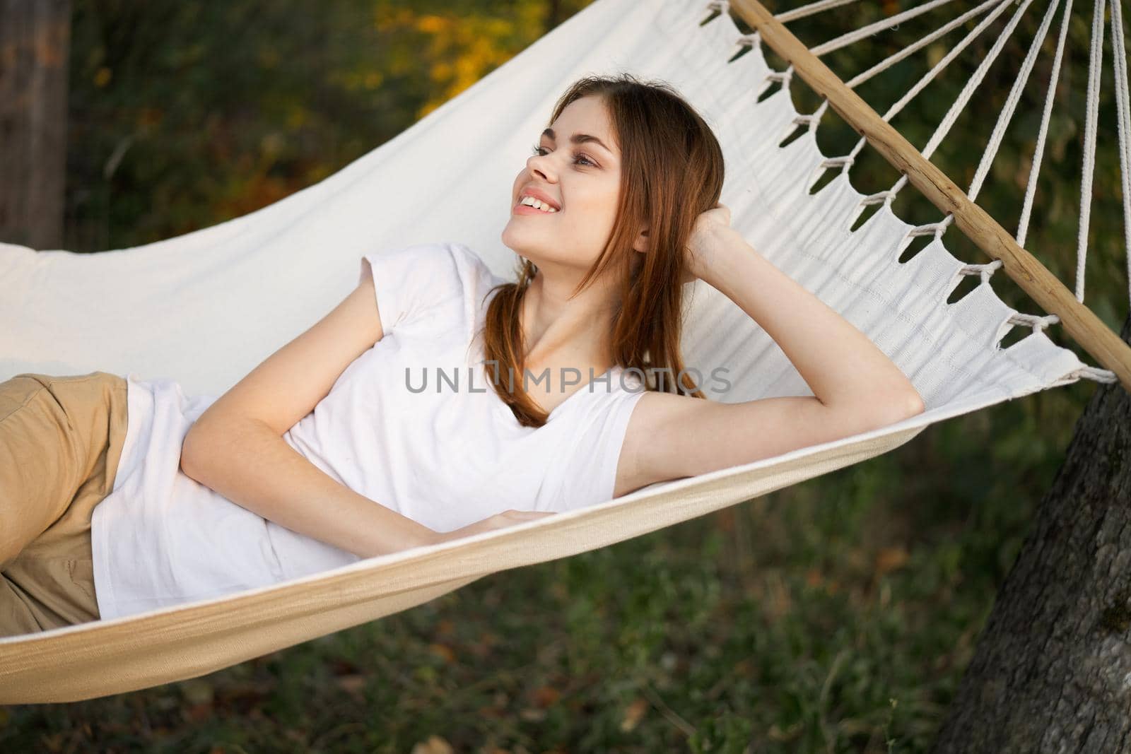 cheerful woman lies in a hammock rest nature fresh air by Vichizh