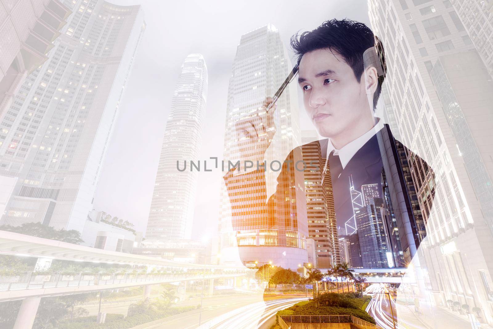 Double exposure of  business man thinking against the city