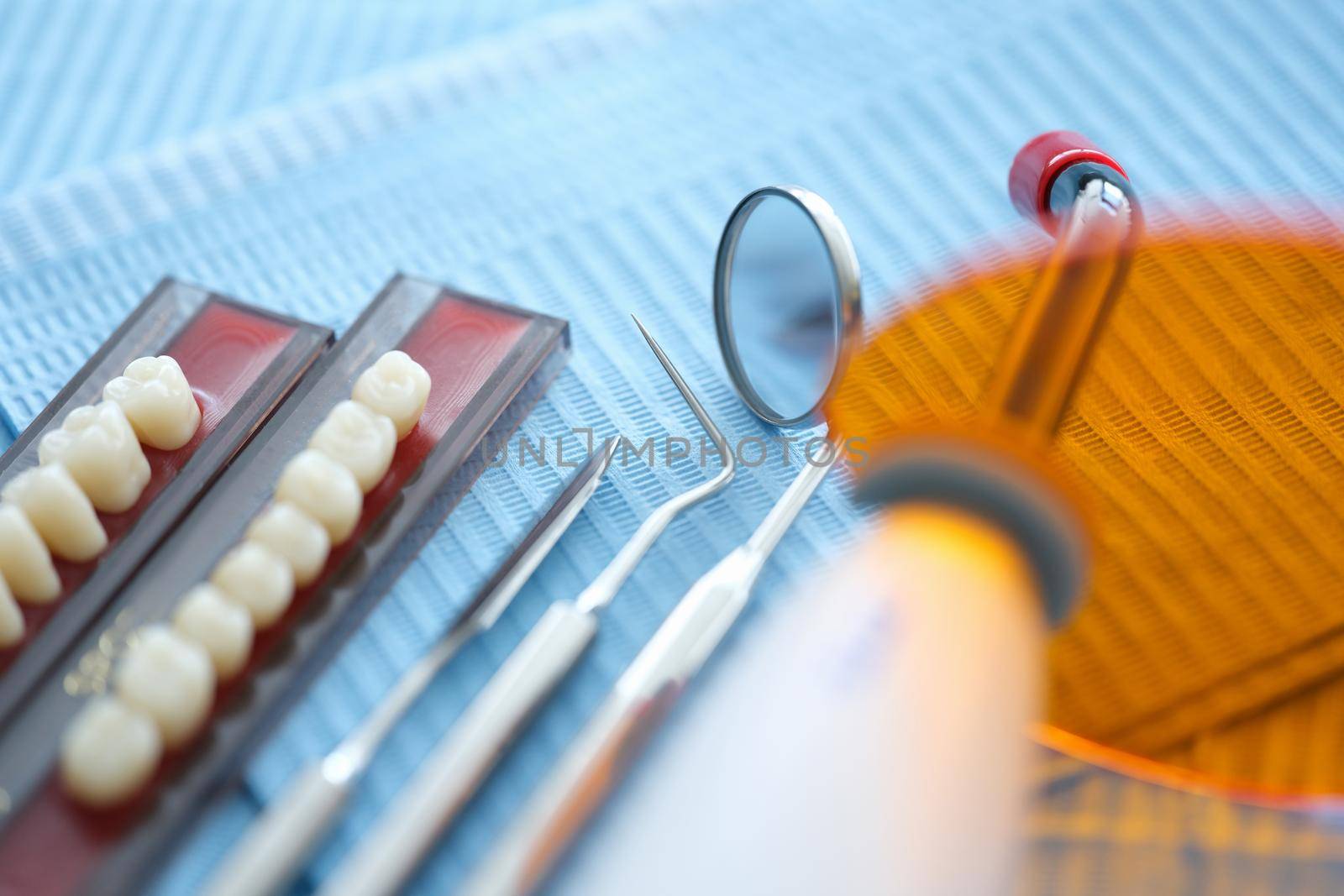 Set of dentures dental instrument laser lamp on table. Dentist services concept