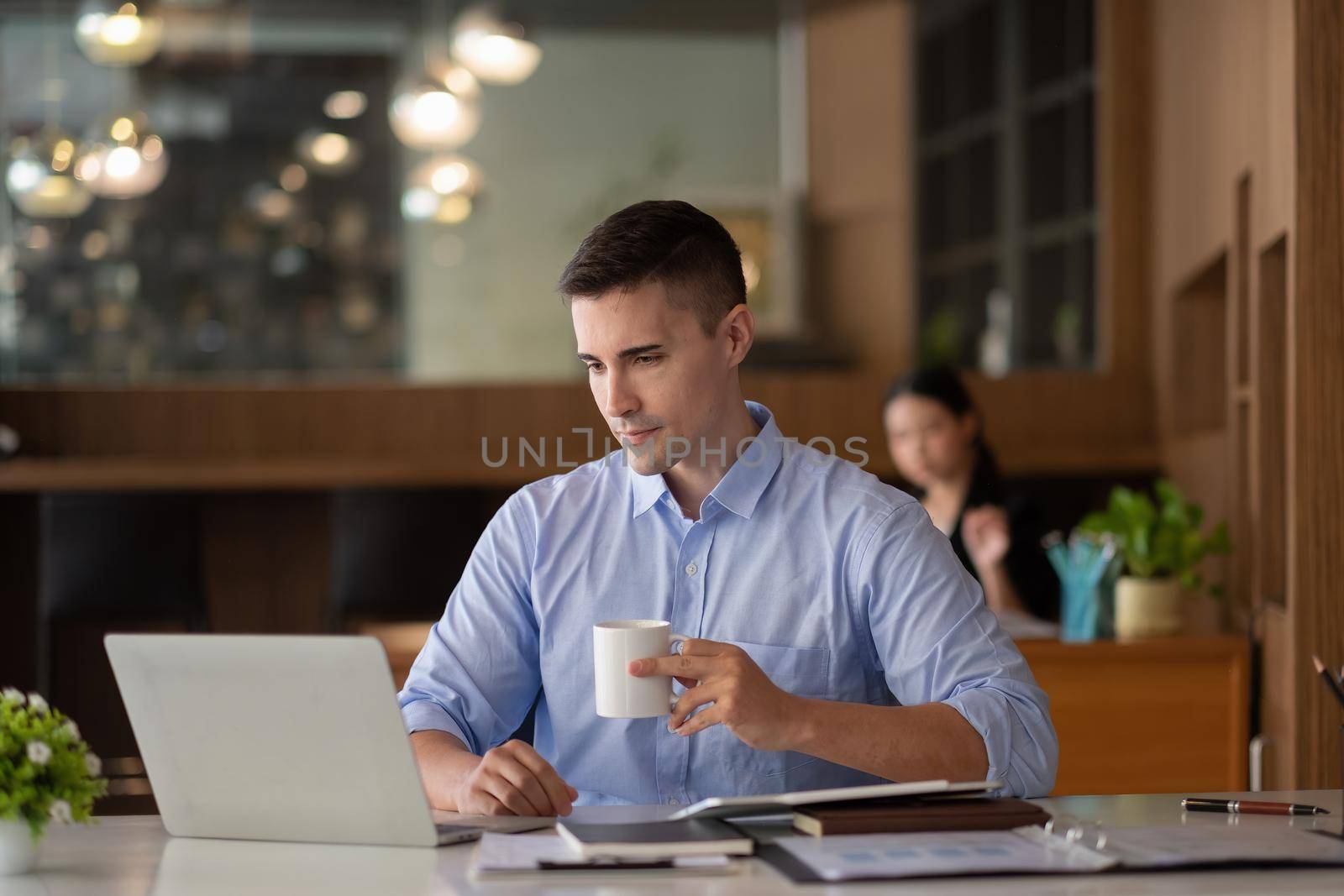 smiling businessman having virtual team meeting call, talking, remotely working at home watching online learning training webinar in remote office.