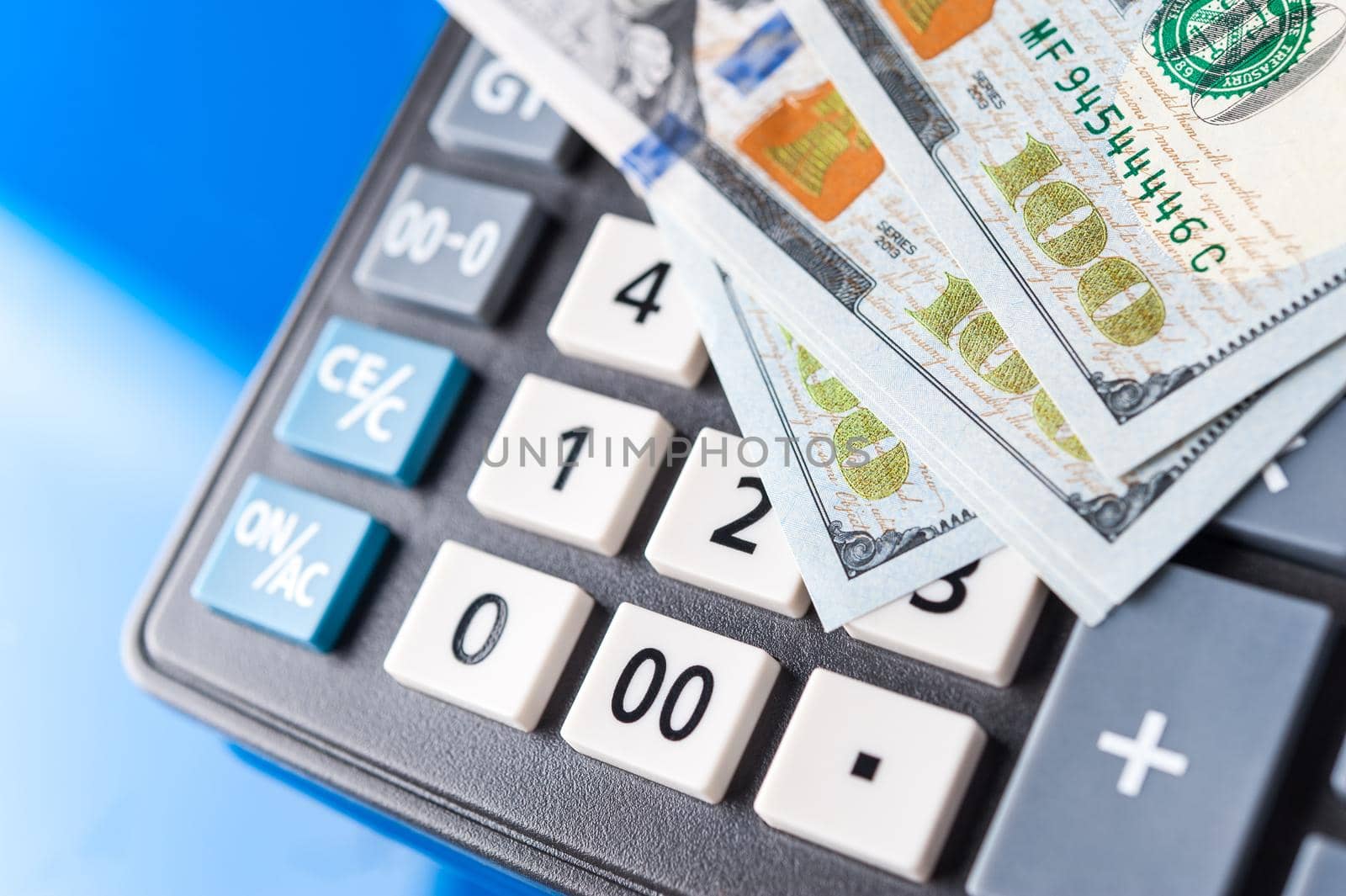 Business and financial background with dollars and calculator. Economy trends background for business idea and all art work design. Abstract bookkeeping background.
